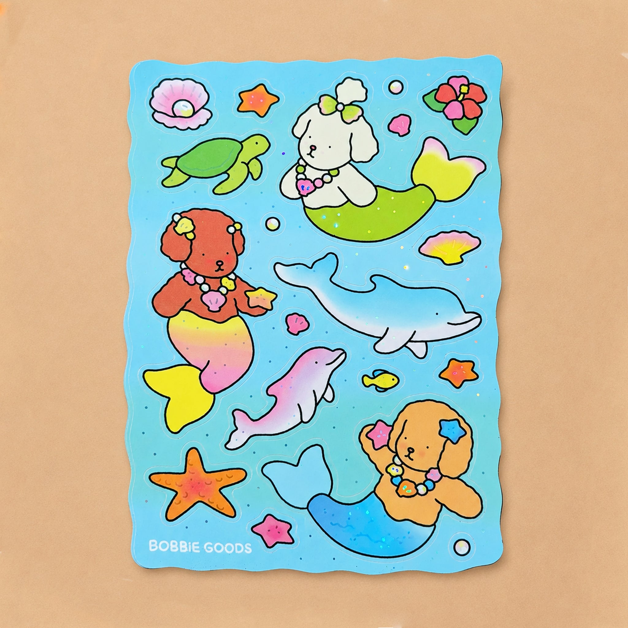 Colorful mermaid-themed stickers with dogs, dolphins, and sea creatures on a blue background.