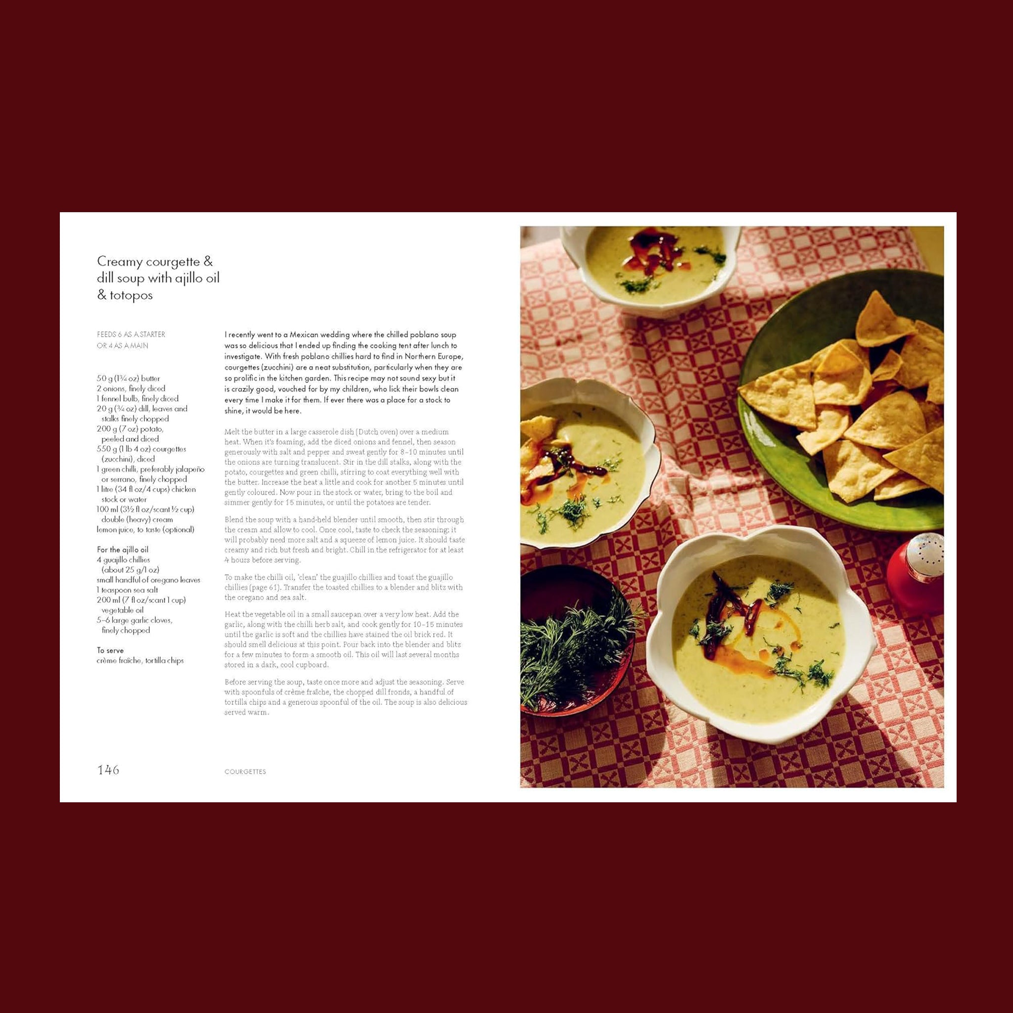 A book with ingredients and instructions and a photo of a table with chips and soup. 