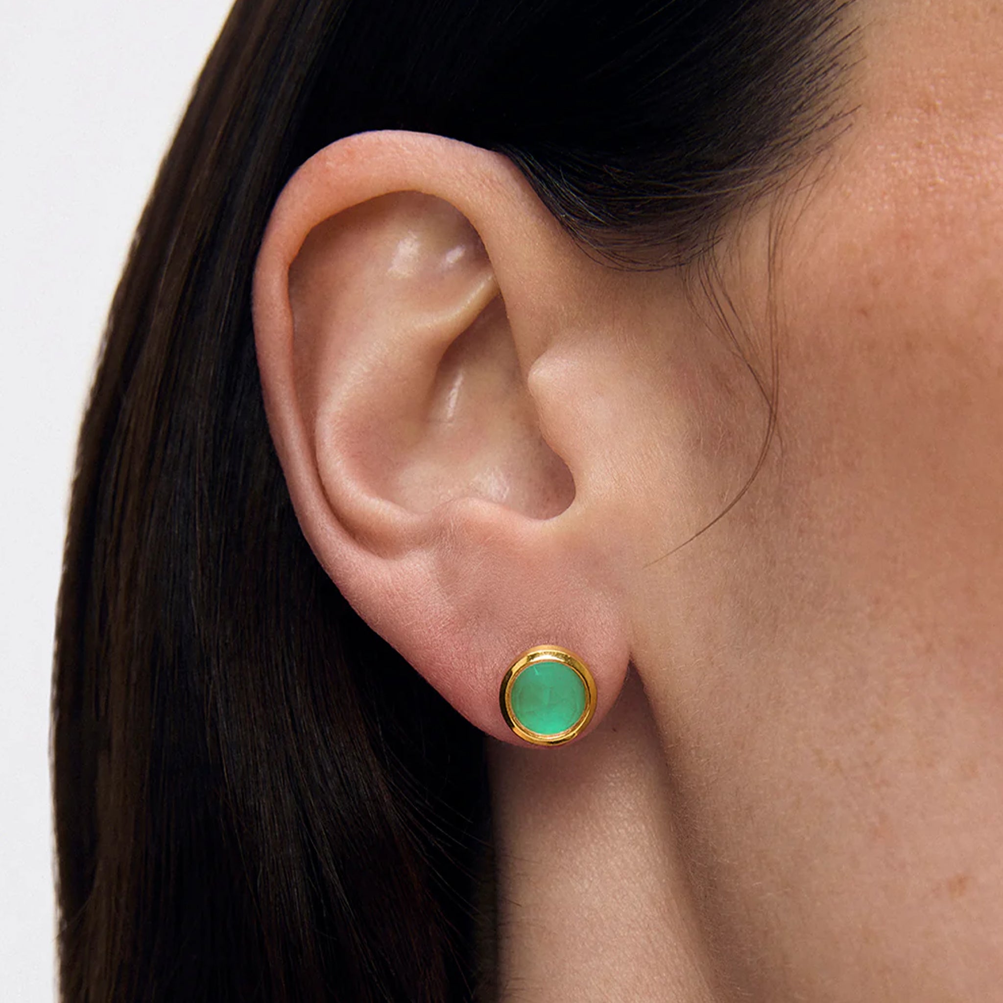 A pair of gold studs with a turquoise cz center. 