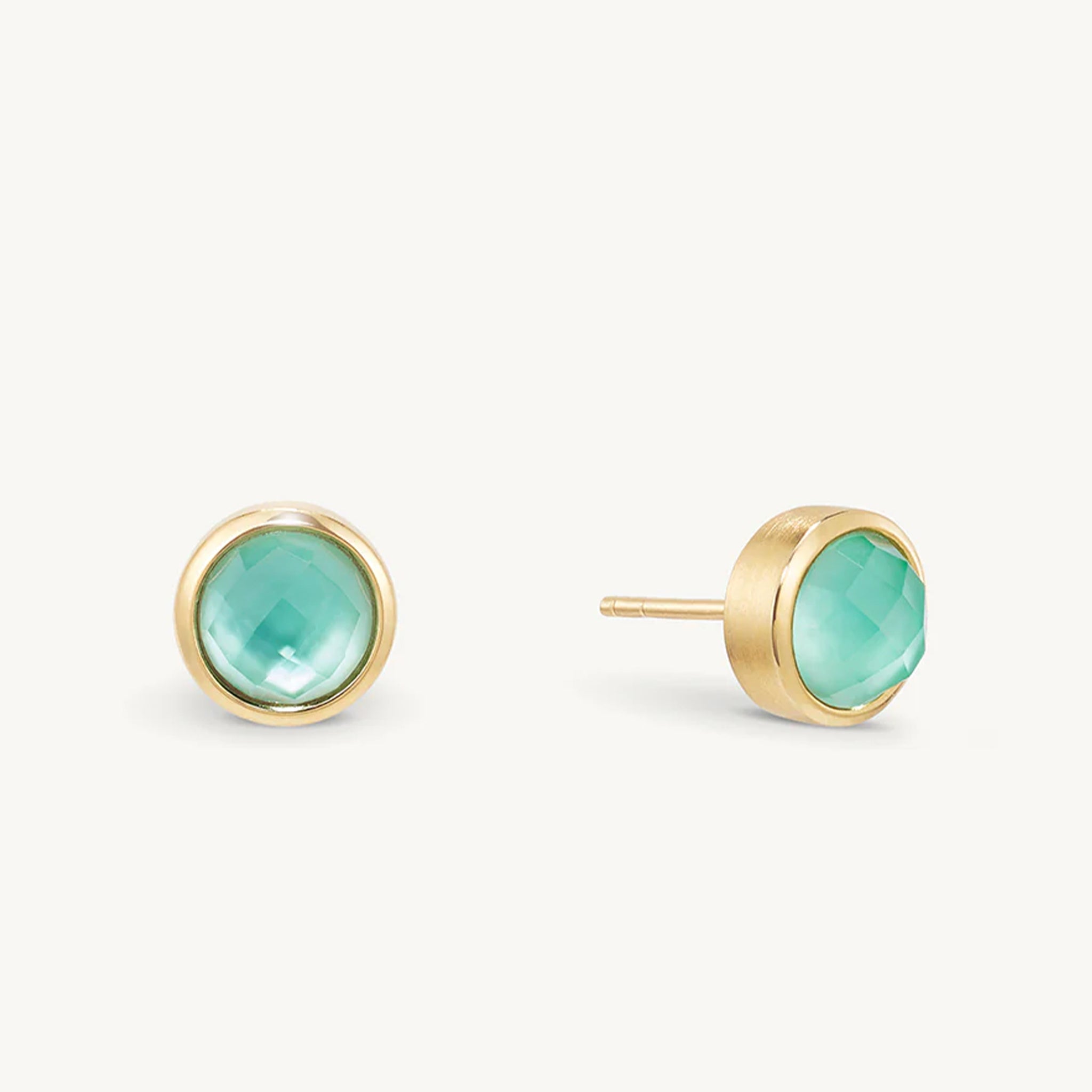 A pair of gold studs with a turquoise cz center. 
