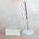 A milky white glass bubble incense holder. 