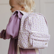 A light pink floral print backpack. 