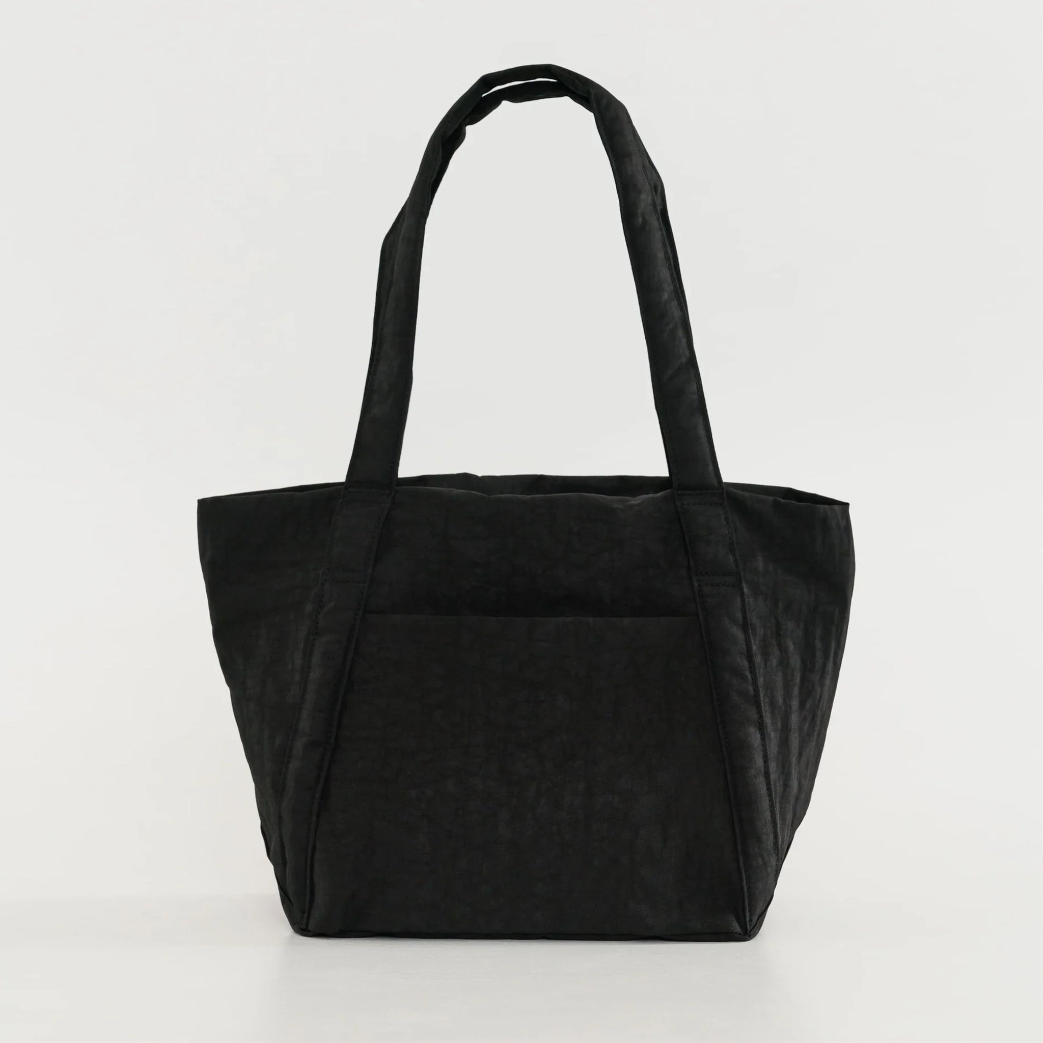 On a white background is a the Mini Cloud Bag in the shade black. It is a rectangular shaped puffy bag with shoulder straps and a wide opening.
