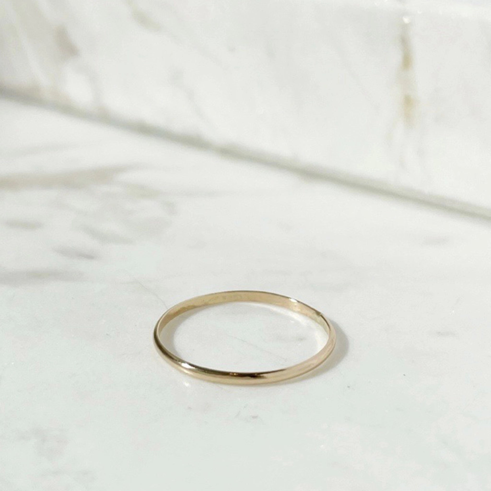 A minimal gold band ring. 