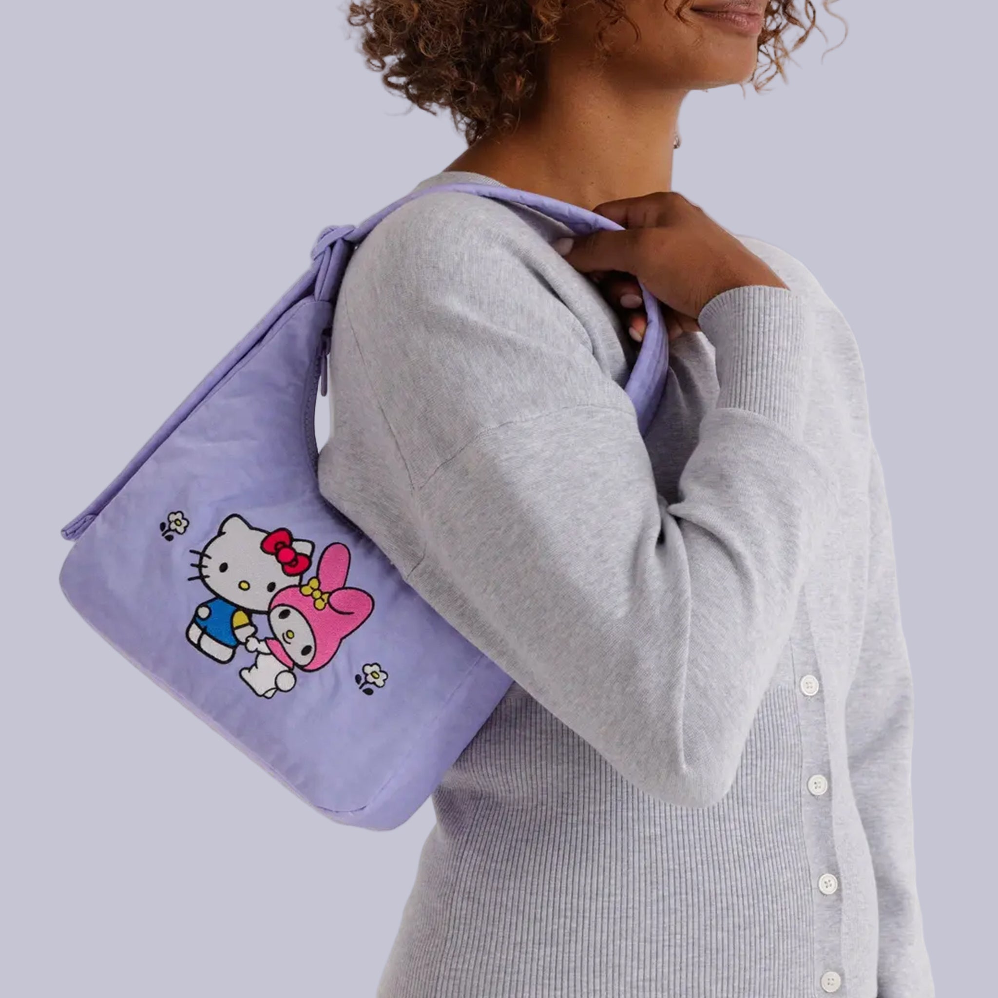 A light purple mini shoulder bag with embroidered my melody and hello kitty design. 