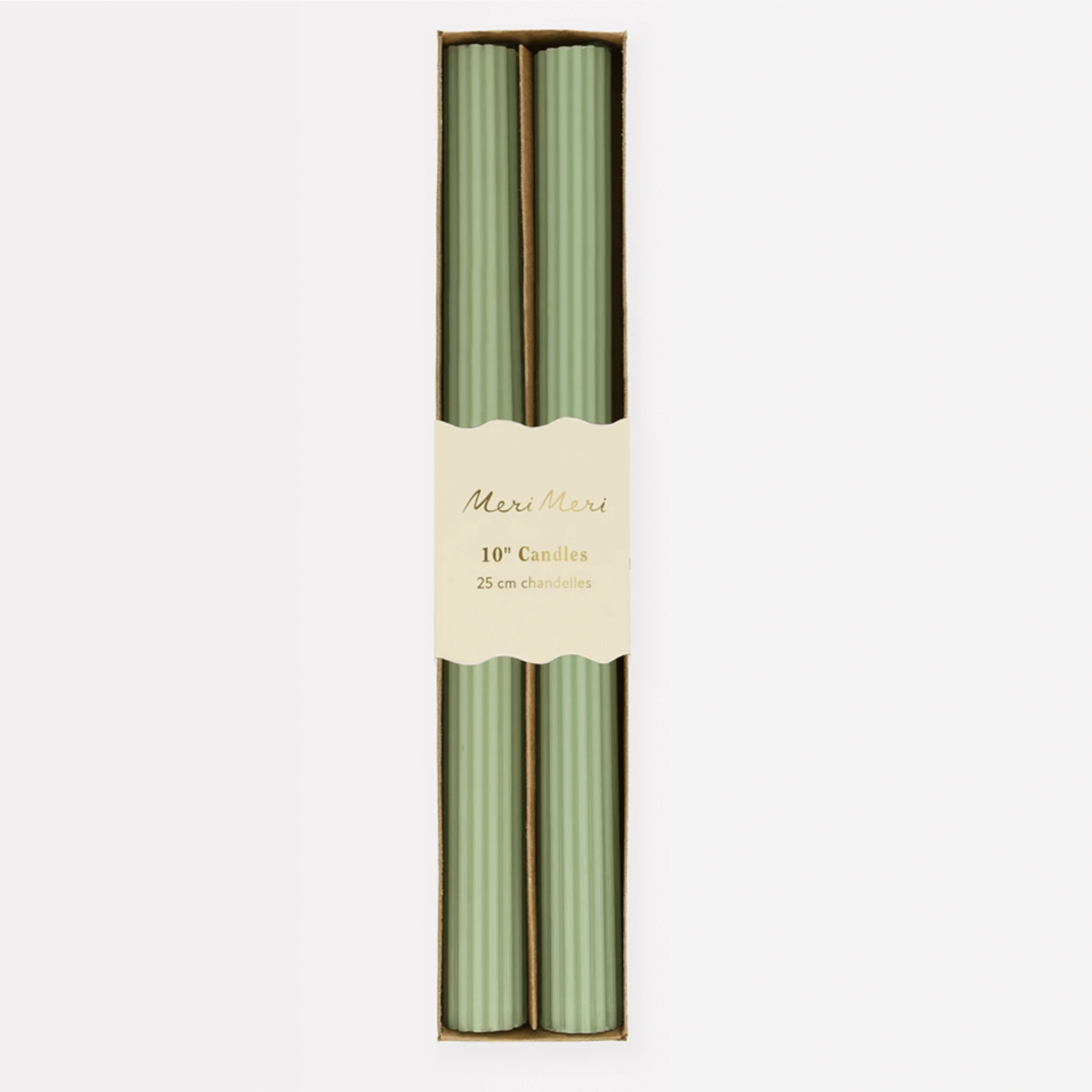 On a white background is a pair of green taper candles in their packaging with a ridged detail on each candle. 
