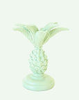 A palm tree shaped resin candle taper holder in mint color.