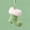 A small Christmas stocking ornament in light green with a fluffy white faux-fur trim and a green ribbon hanger, shown against a solid light green background.