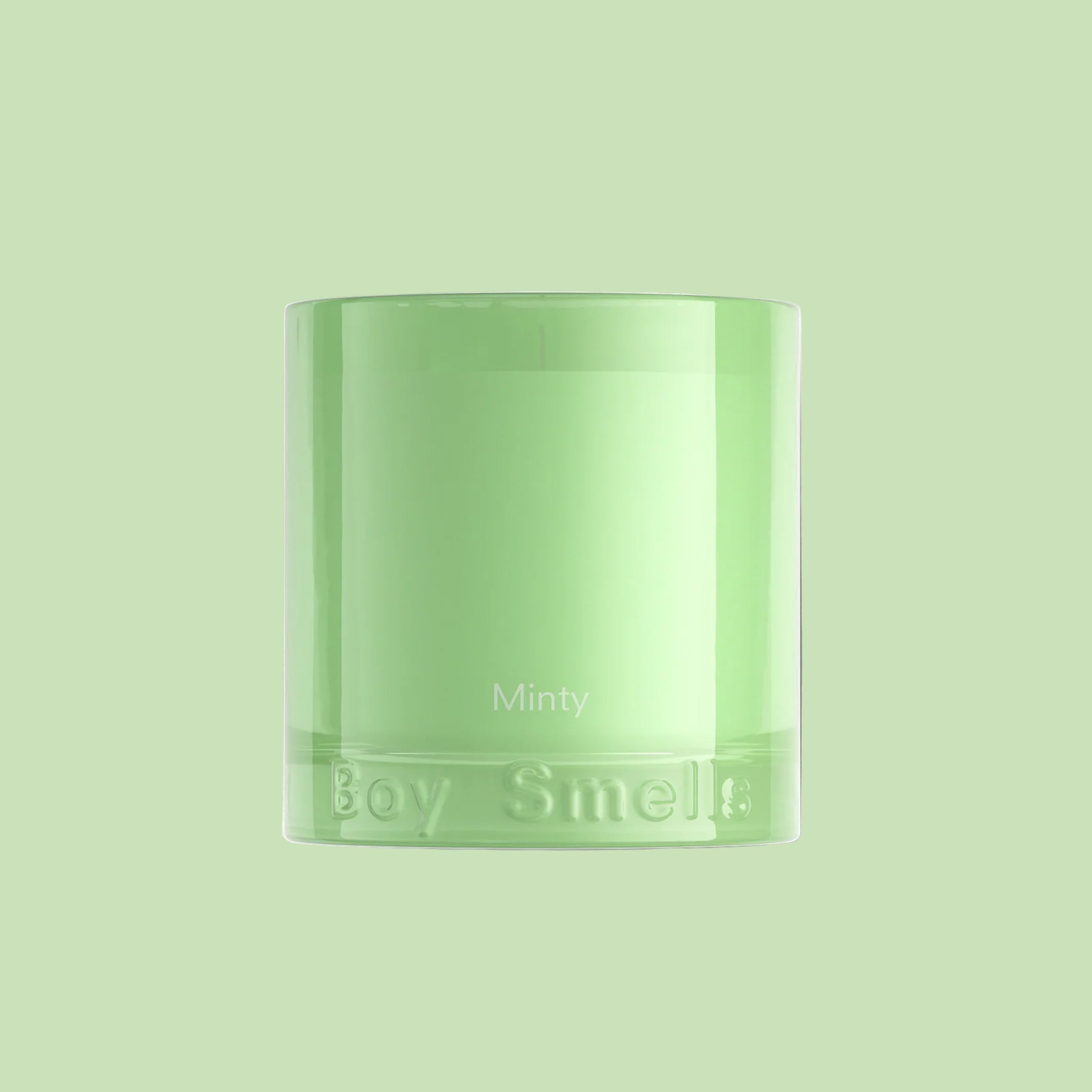 A green glass candle with text that reads, 'Minty Boy Smells'. 