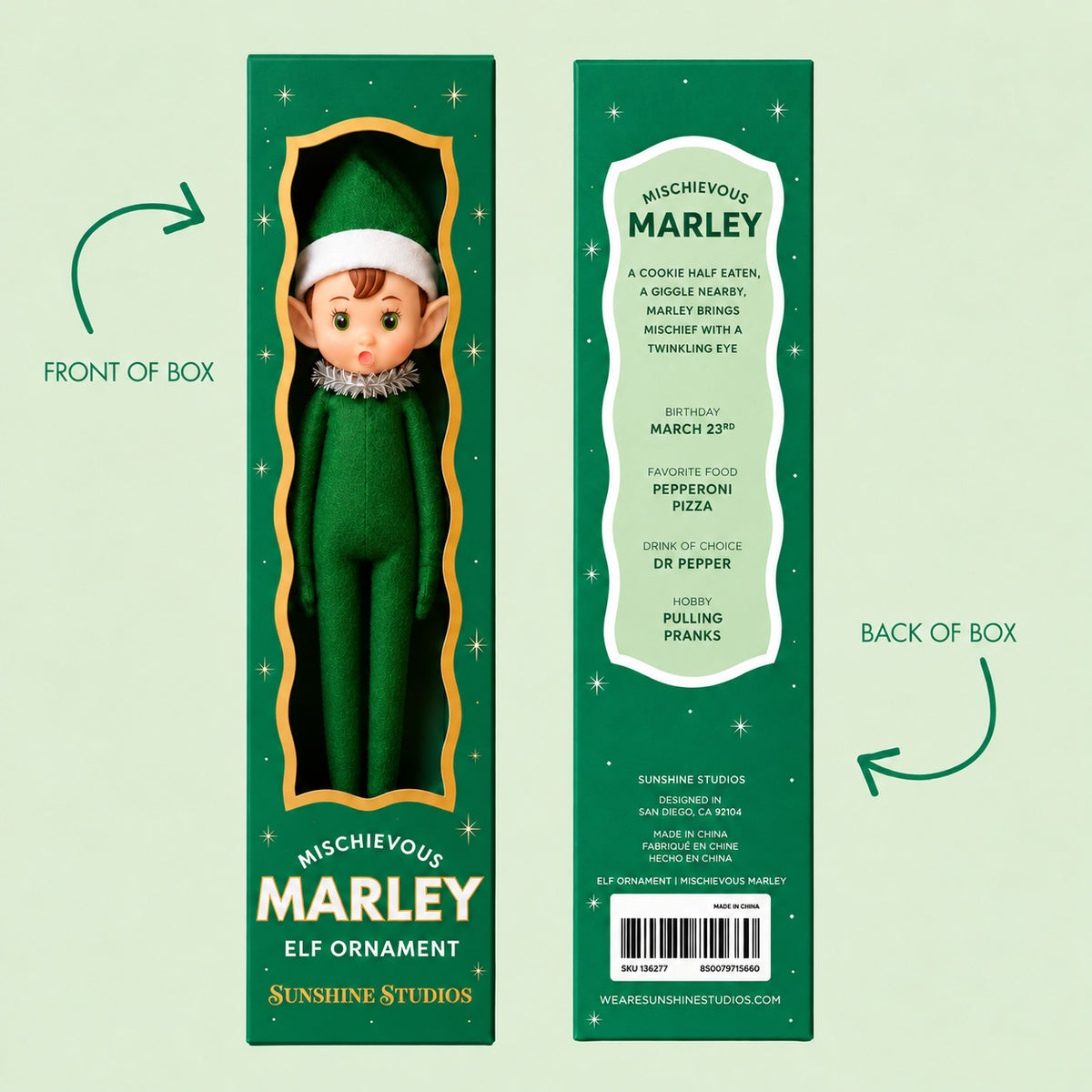 A green elf ornament in a box.