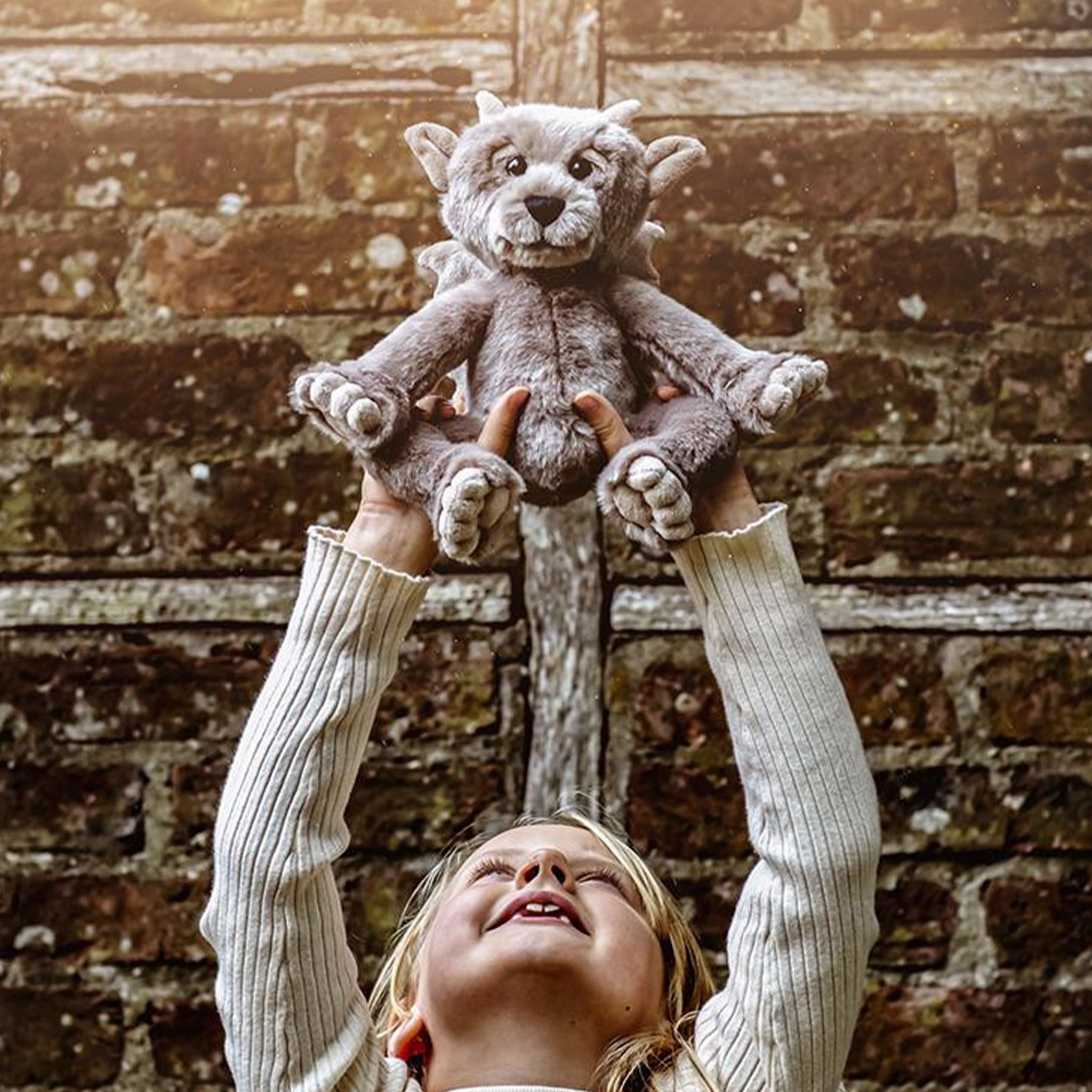 A grey mythical stuffed animal toy. 