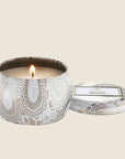 A decorative tin single wick candle with a lid and a label that reads, "Voluspa Mokara"