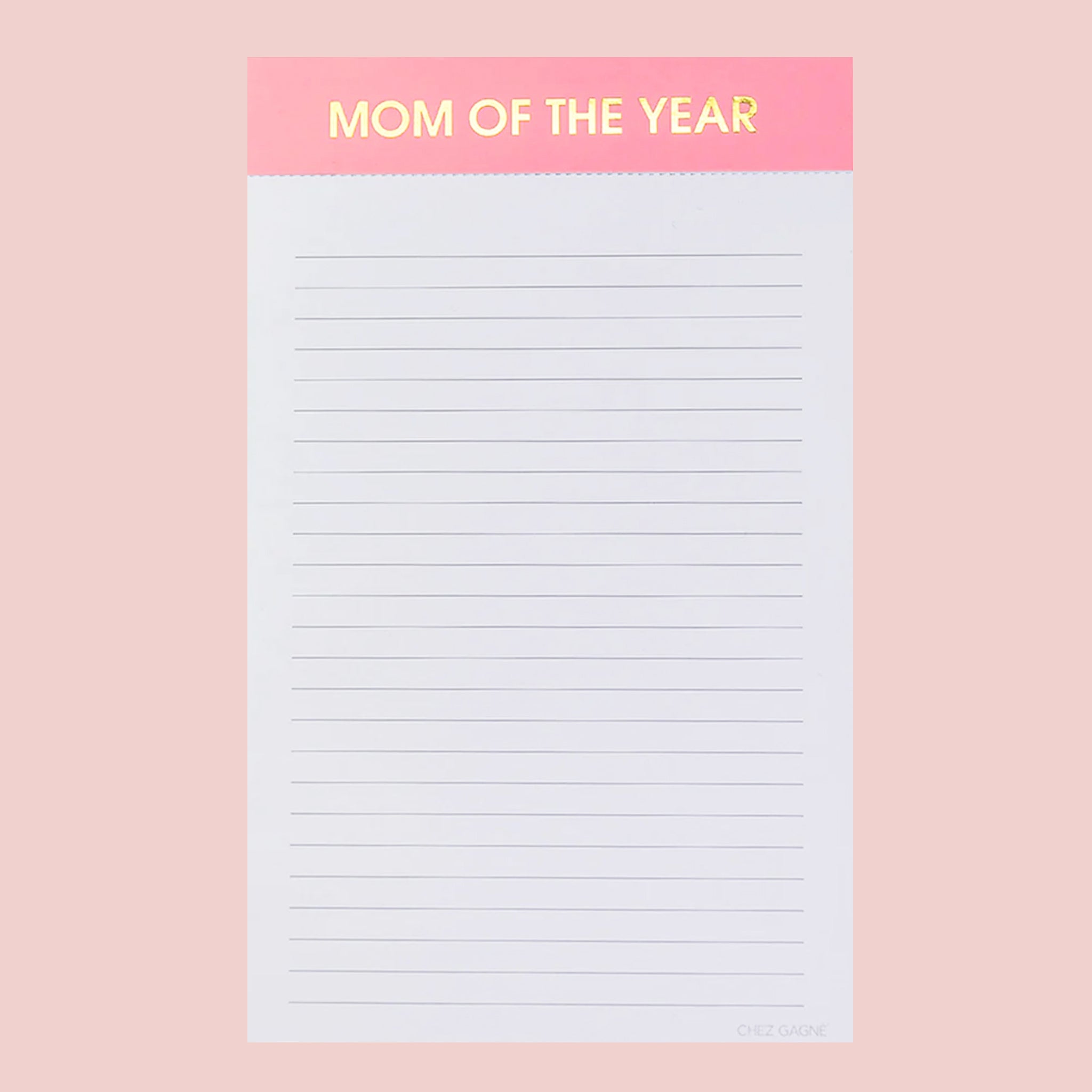 On a pink background is a lined notepad with a pink header that reads, "MOM OF THE YEAR" in gold foil letters. 