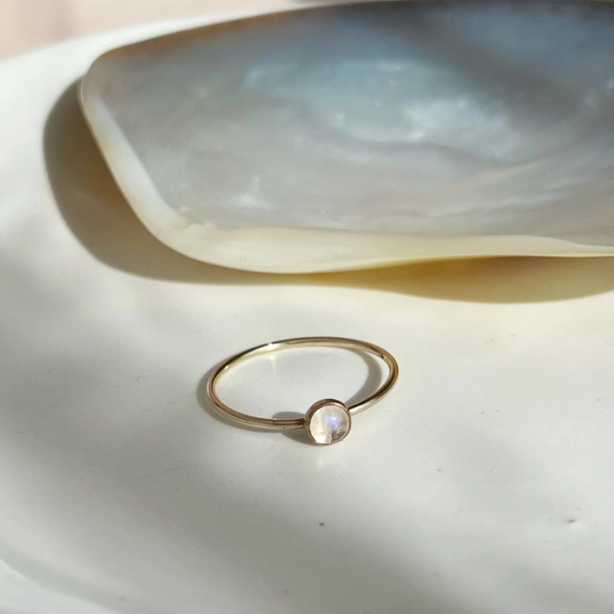 A gold thin ring with a moonstone in the center. 