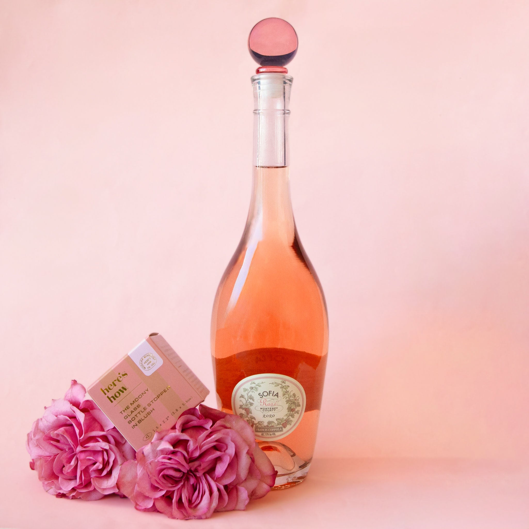 A pink glass round bottle stopper. 