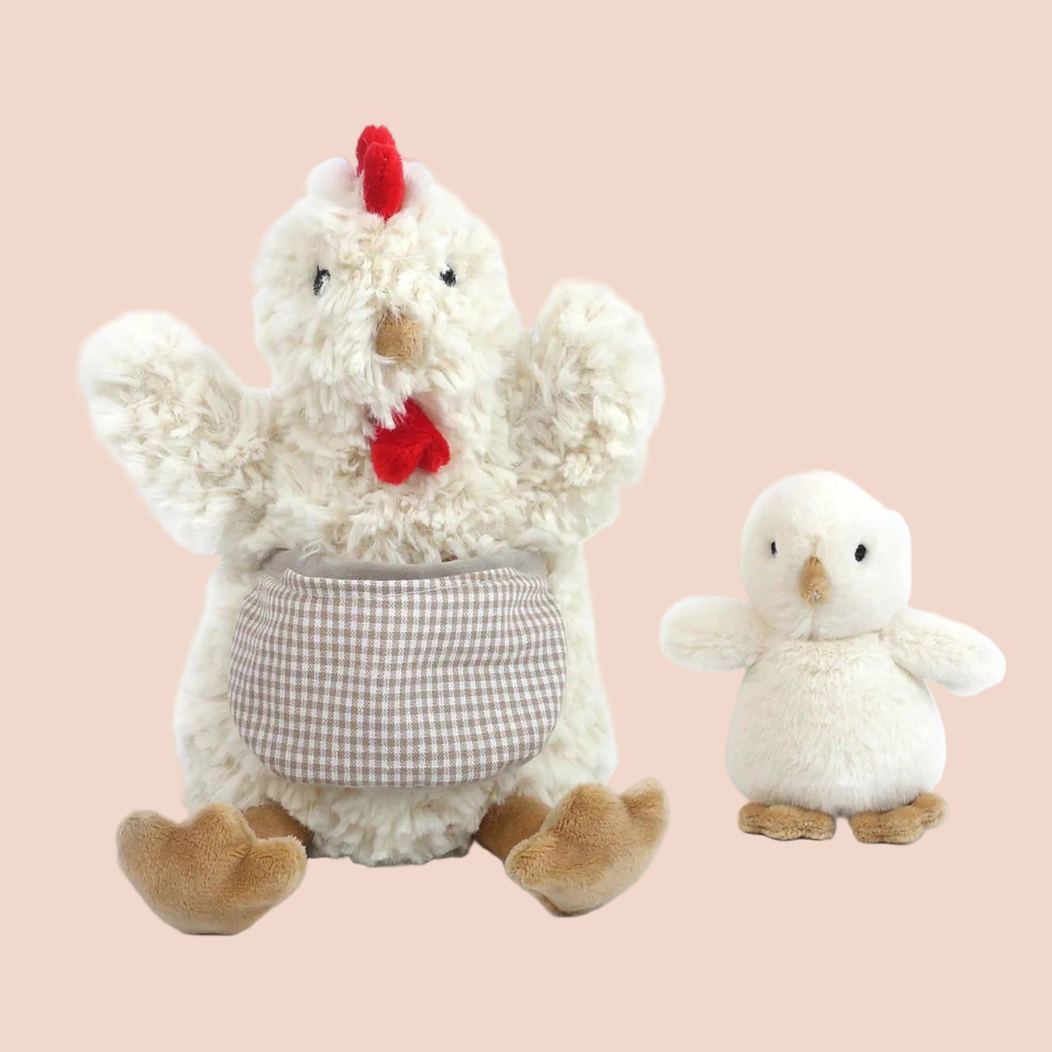 A mother hen and baby shaped stuffed animal duo. The mother hen is wearing an apron. 