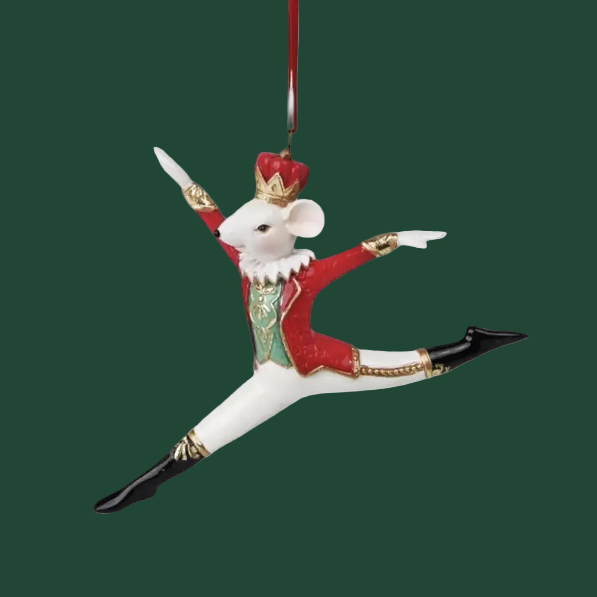 A mouse shaped ornament with a red nutcracker outfit. 
