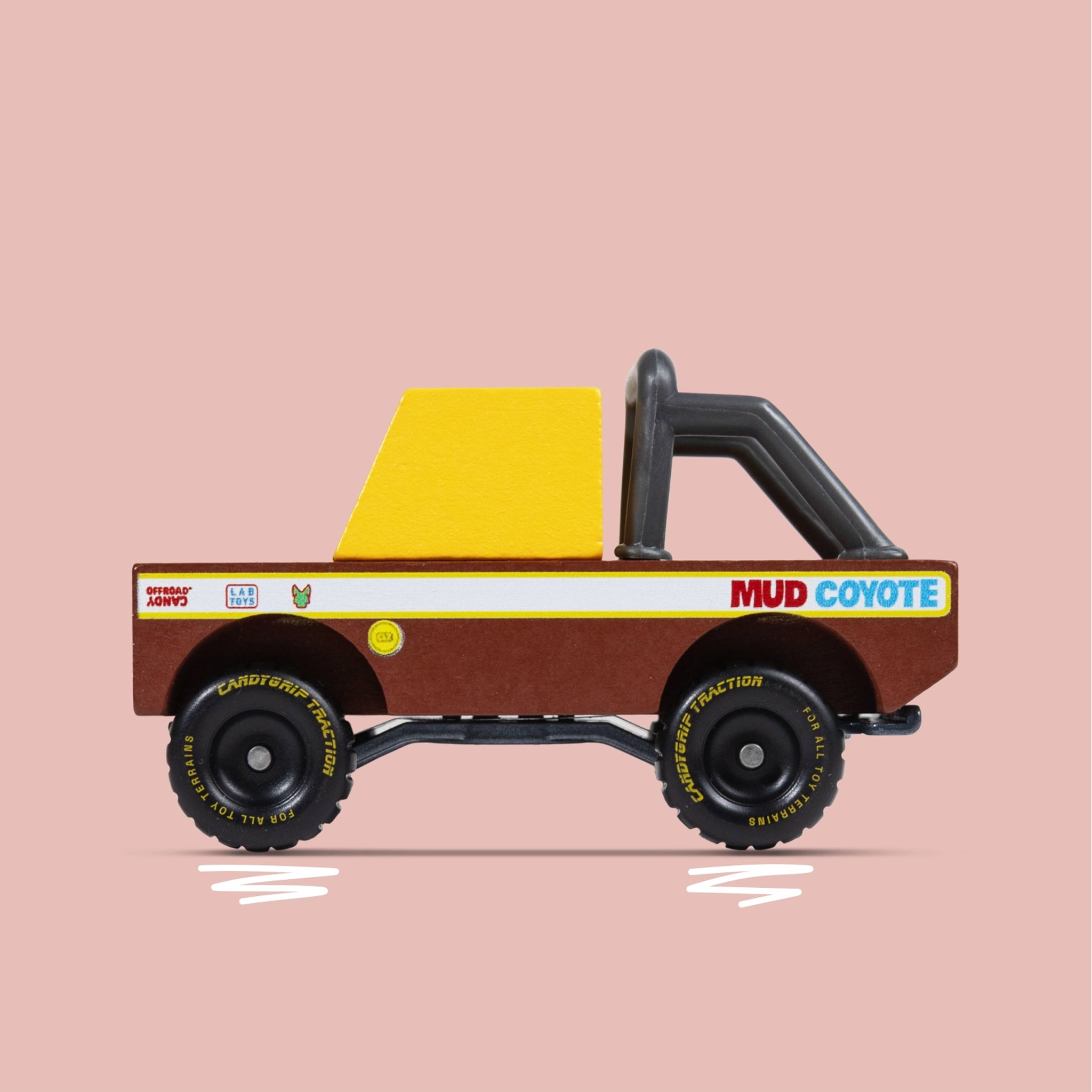 A brown and yellow mud truck wooden toy. 