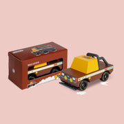 A brown and yellow mud truck wooden toy. 