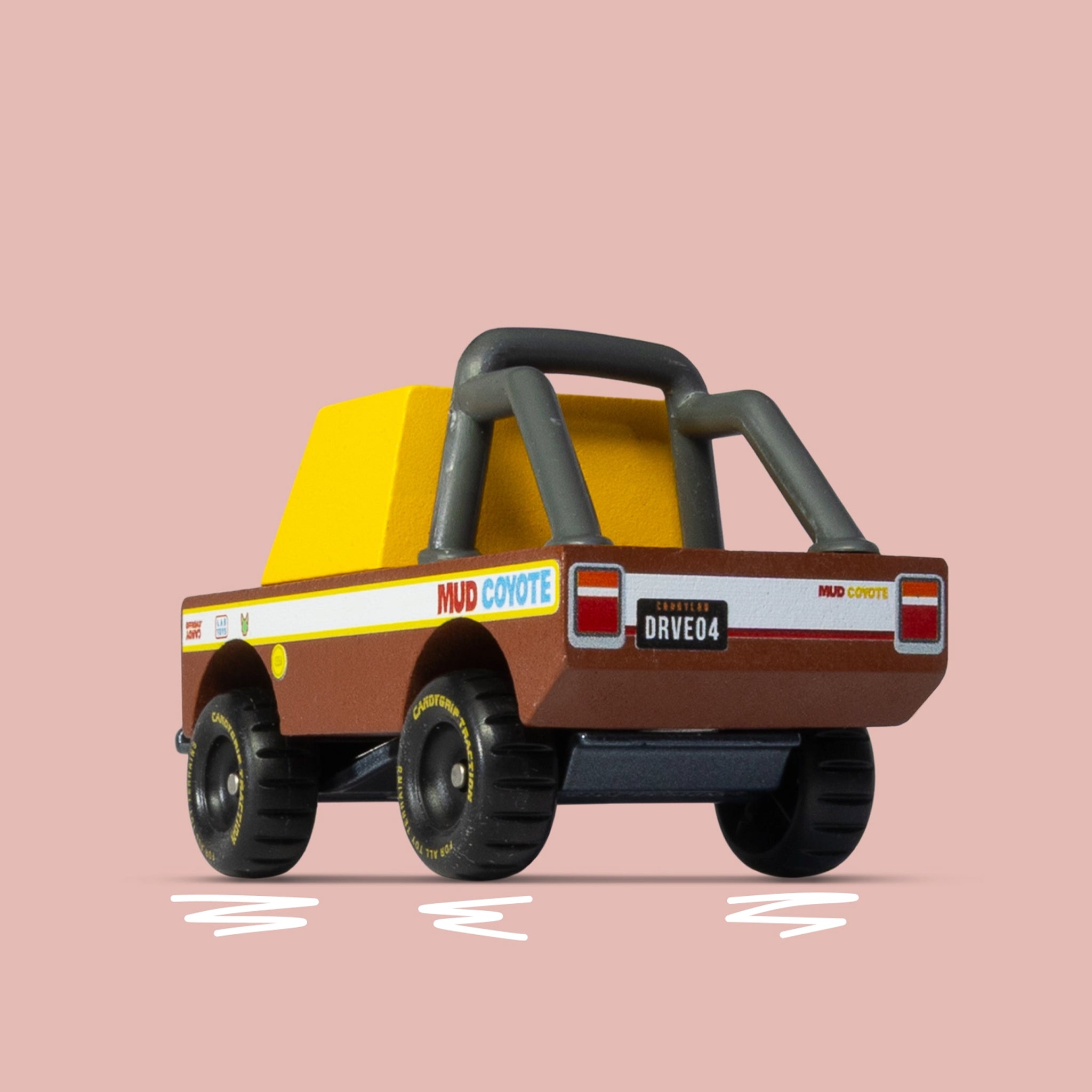 Toy truck with a yellow bed and brown body on a pink background