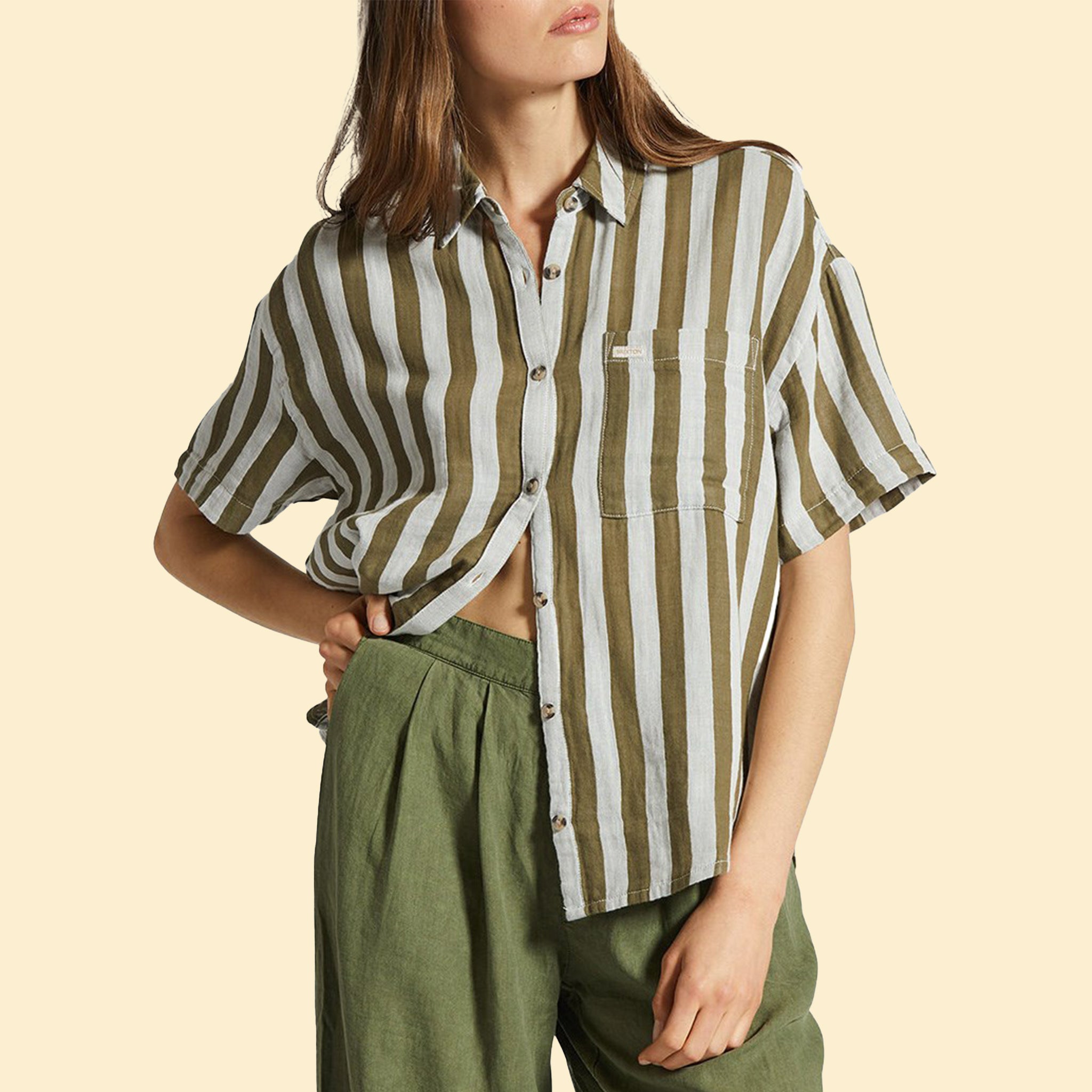 A collared short sleeve button up shirt with white and olive green stripes. 