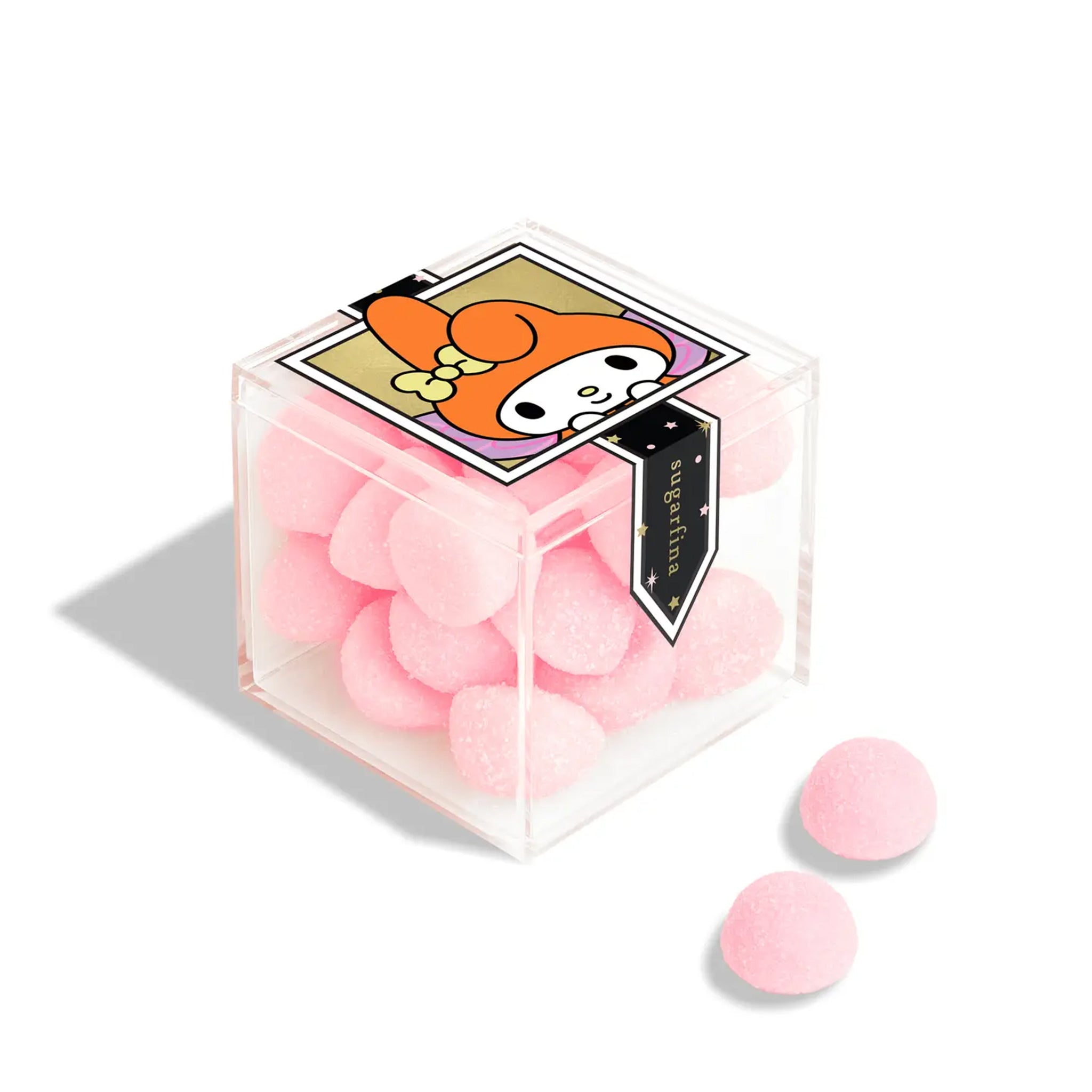 A clear acrylic case of pink bon bon candies with a My Melody design on the front. 