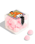 A clear acrylic case of pink bon bon candies with a My Melody design on the front. 