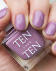 A purple nail polish with a satin/gloss finish. 