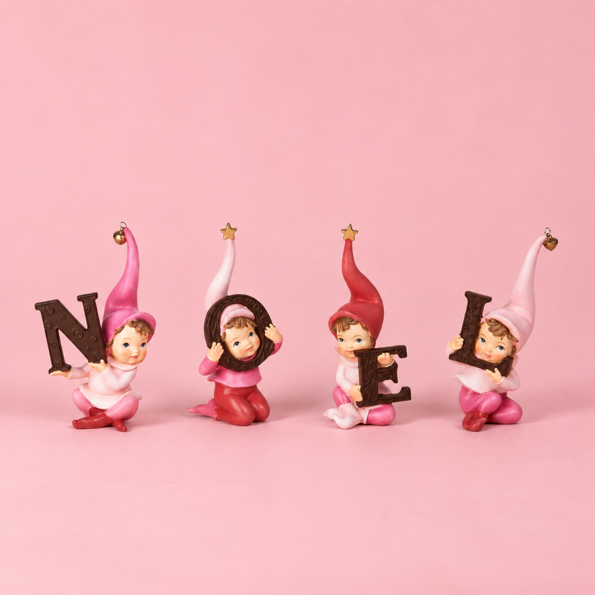 Christmas decorative elves holding the letters to spell "NOEL". Resin elves have cute pink hats that have bells and stars on them.
