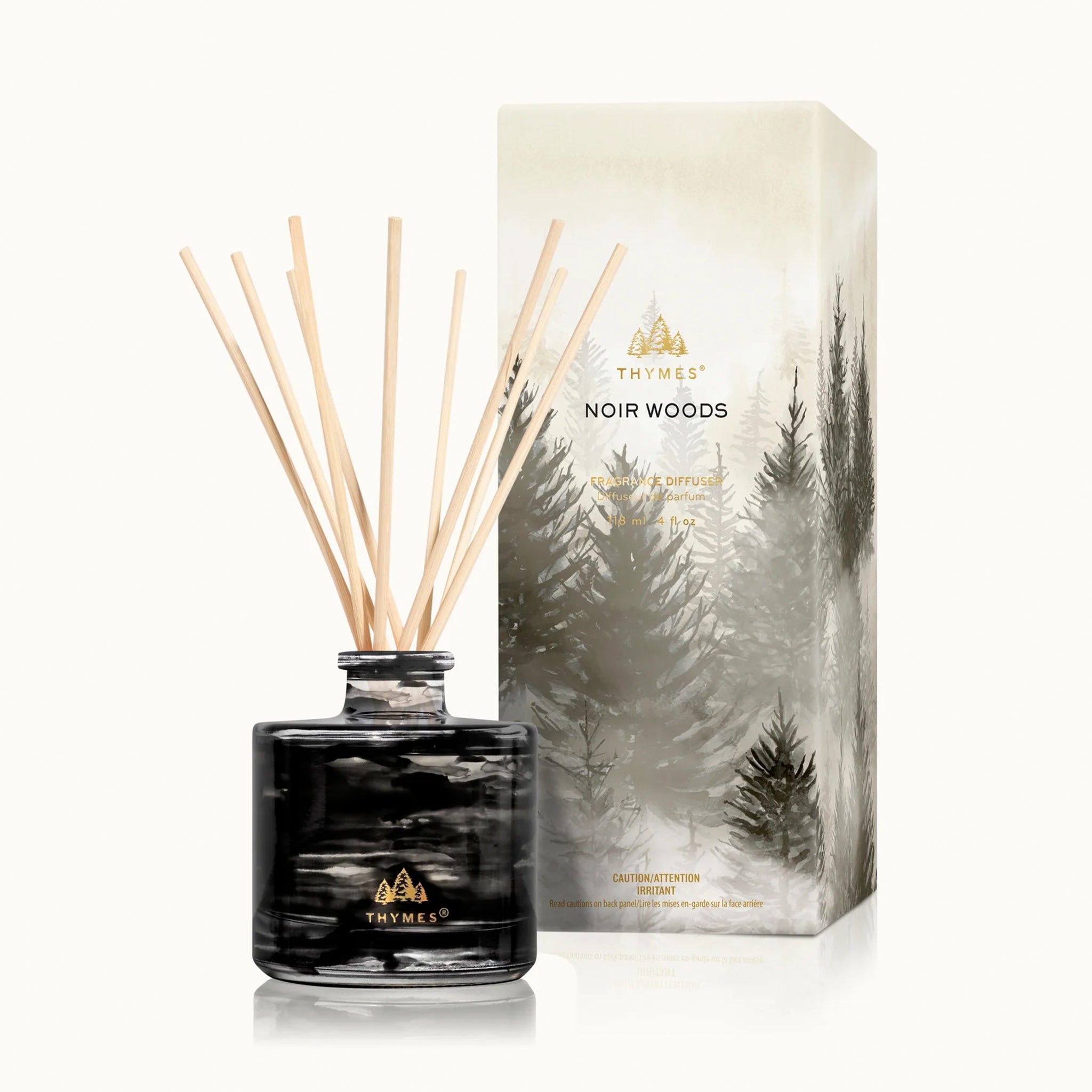 A diffuser with black glass and wooden reeds. 