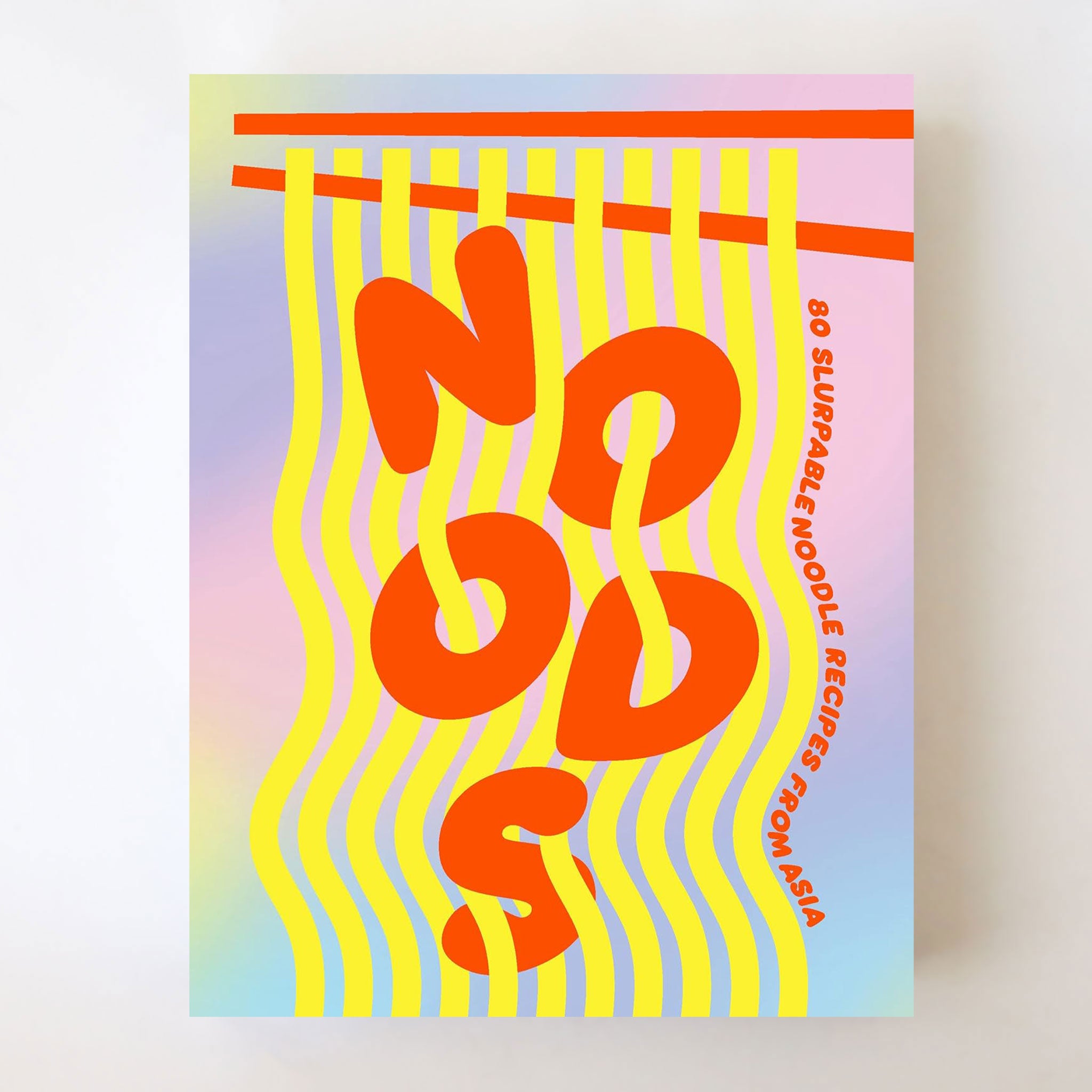 On a neutral background is a ombre purple, blue and pink cookbook cover with bright orange letters that read, "Noods 80 Slurpable Noodle Recipes From Asia". 