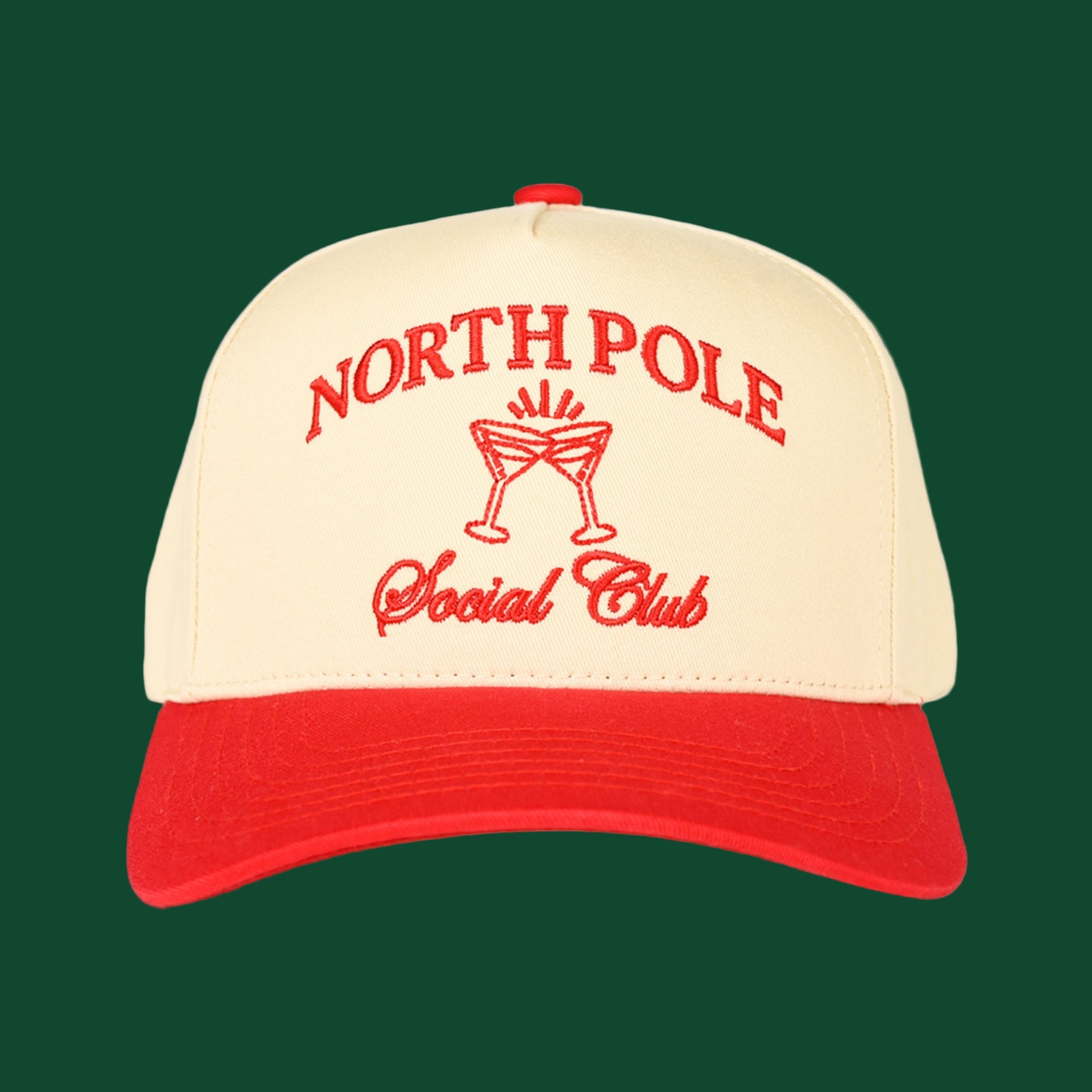 A cream and red trucker hat with embroidered text that reads, "North Pole Social Club". 