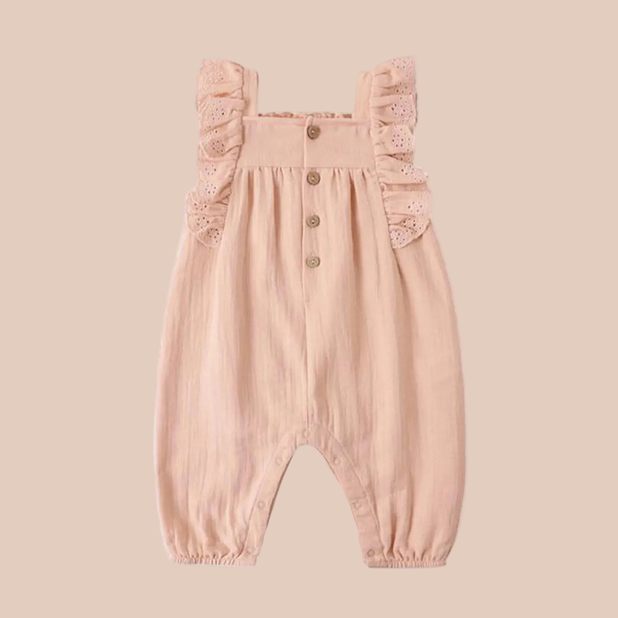 A light peachy colored ruffle romper for kids and babies. 
