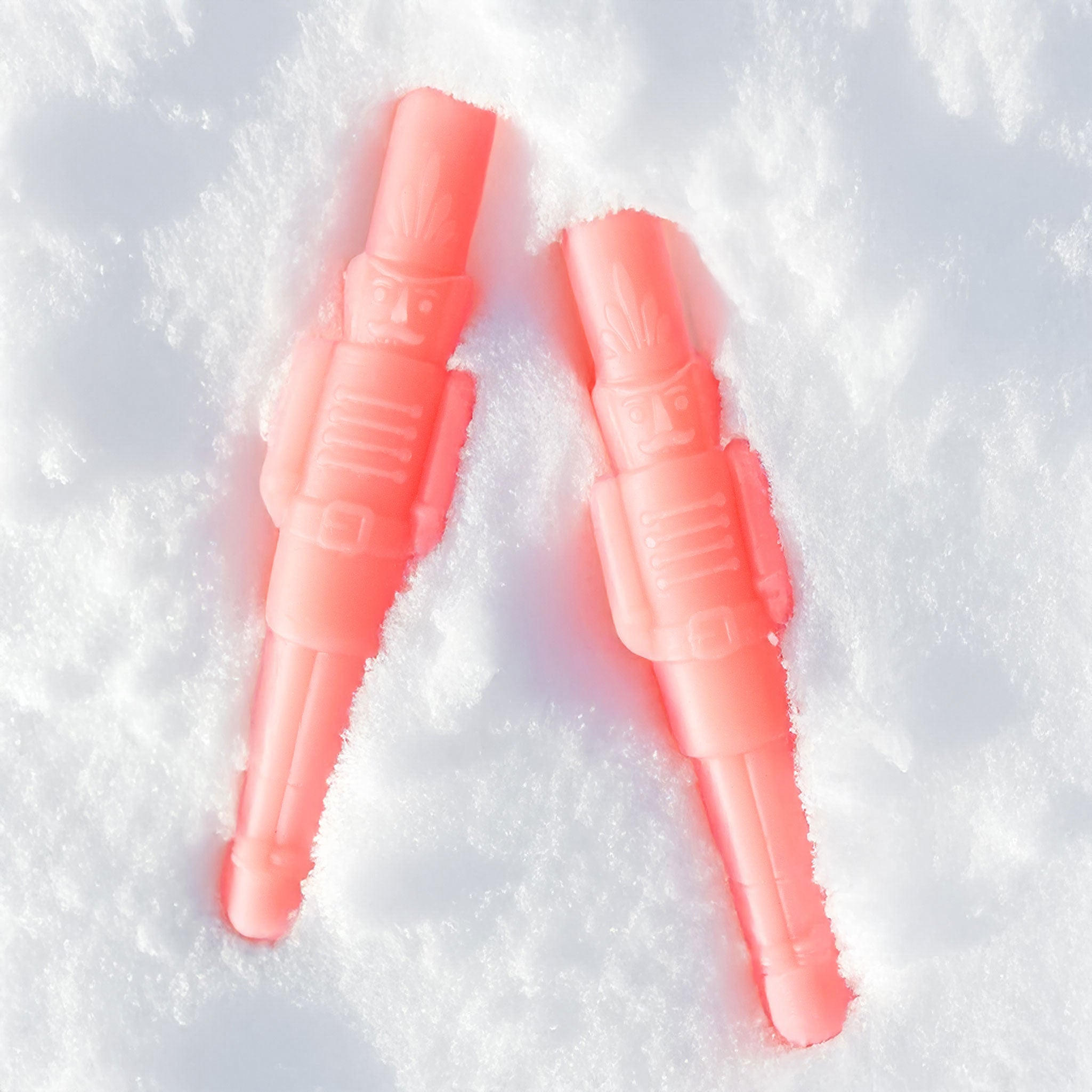 A set of pink nutcracker shaped taper candles. 