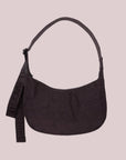 A purple/brownish colored nylon crescent bag with a black strap and details. 