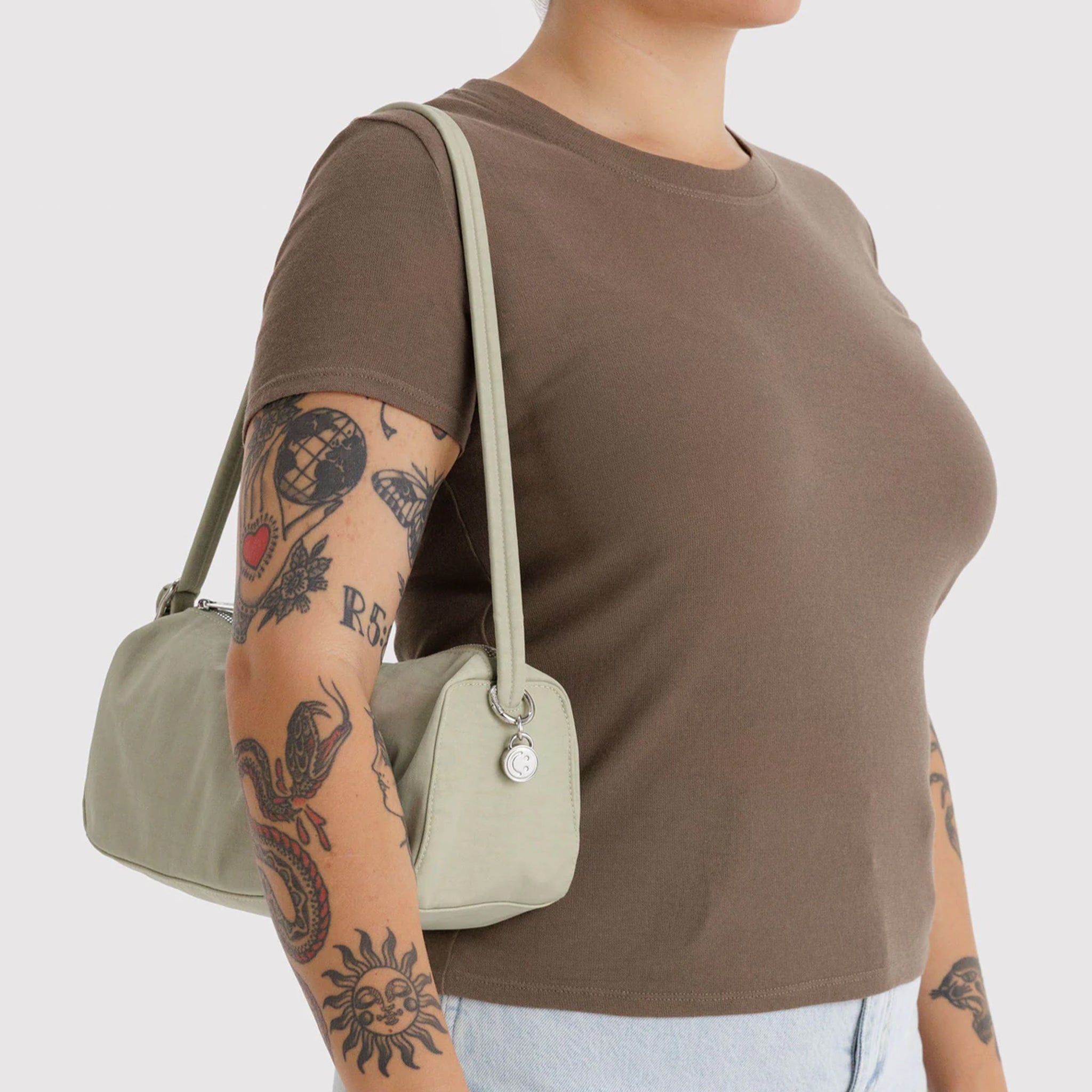 A pale green loaf shaped shoulder bag. 
