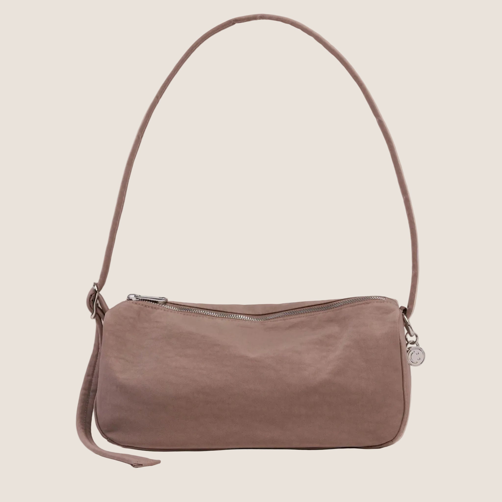 A small loaf shaped nylon tote bag in a mauve color. 