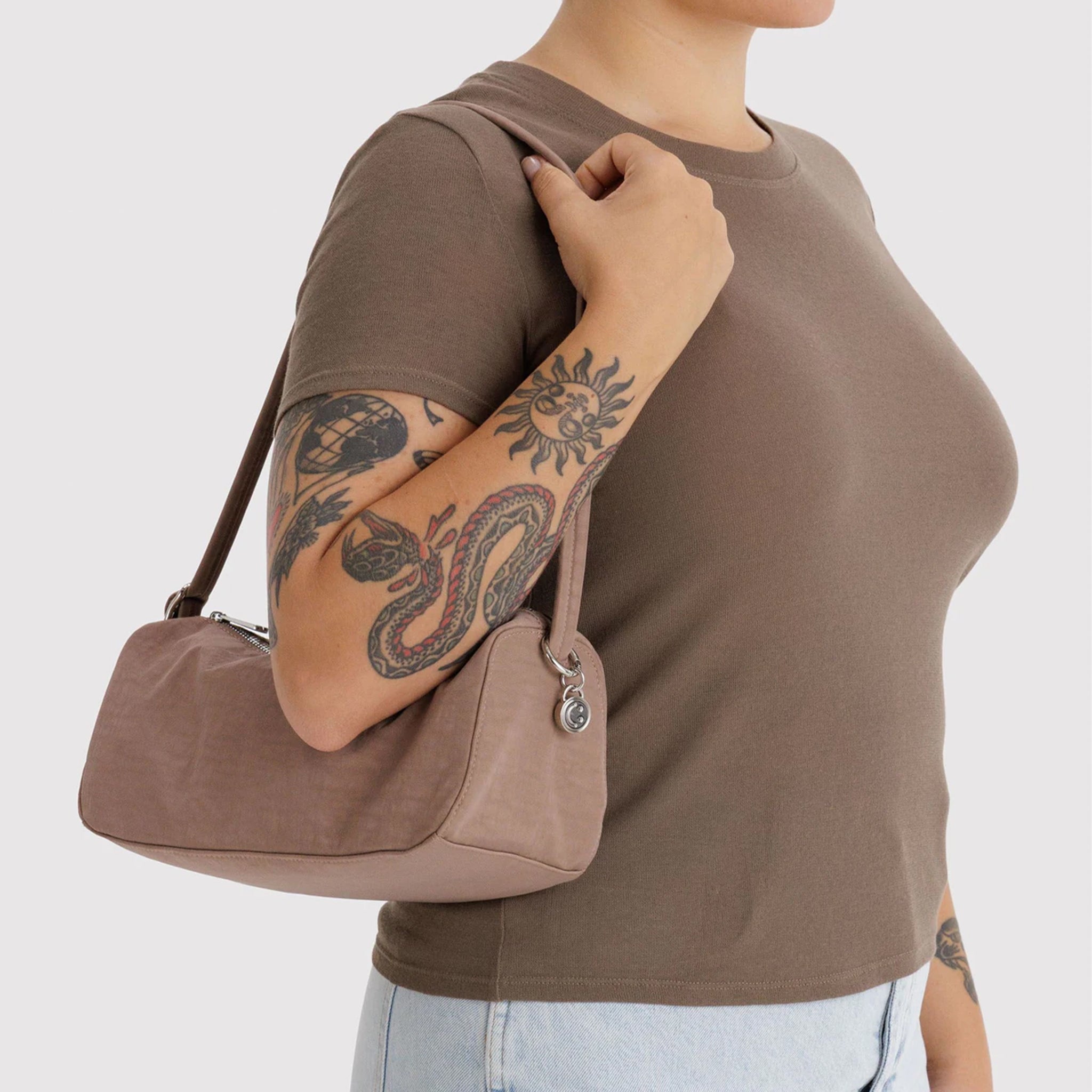 A small loaf shaped nylon tote bag in a mauve color. 