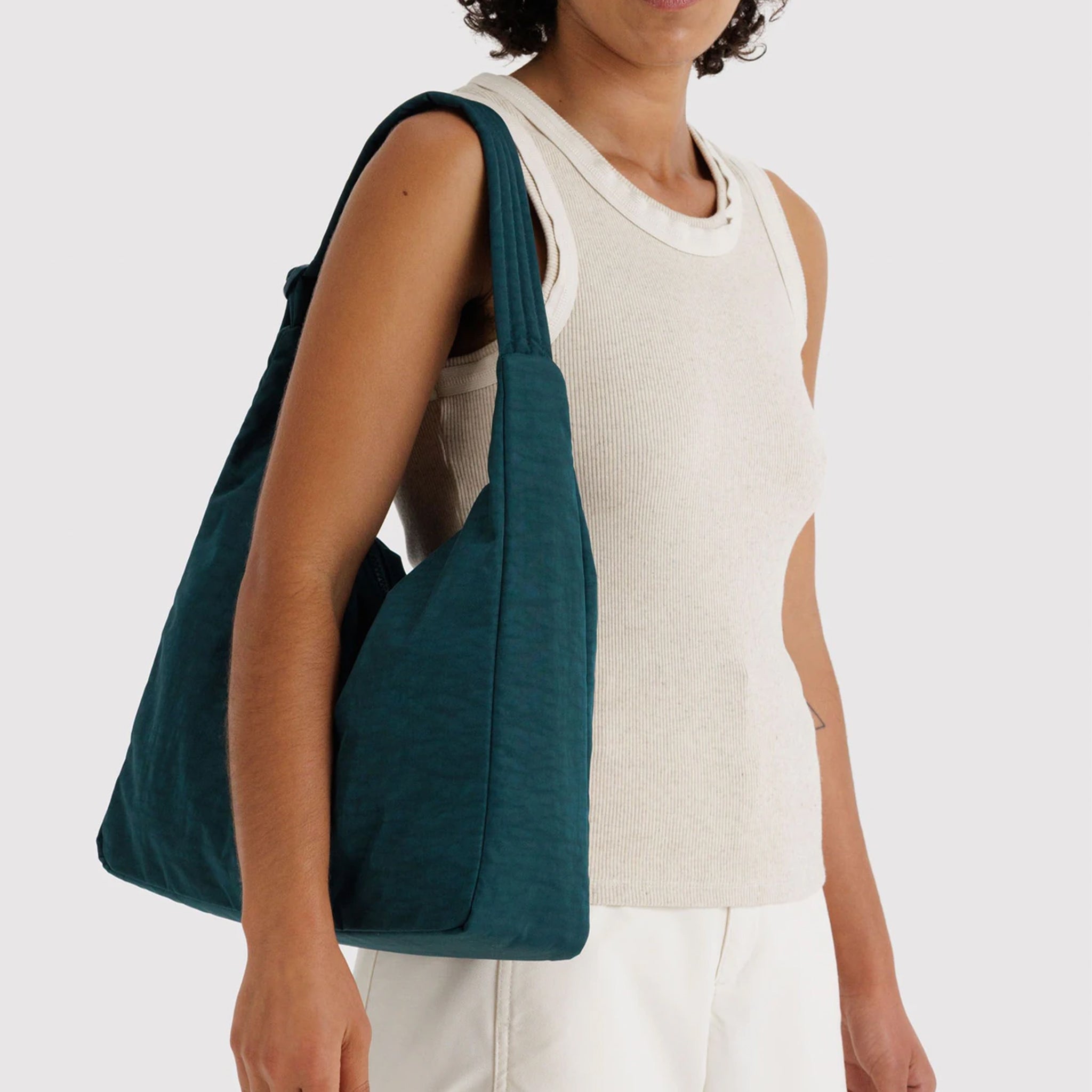 A dark teal nylon shoulder bag. 