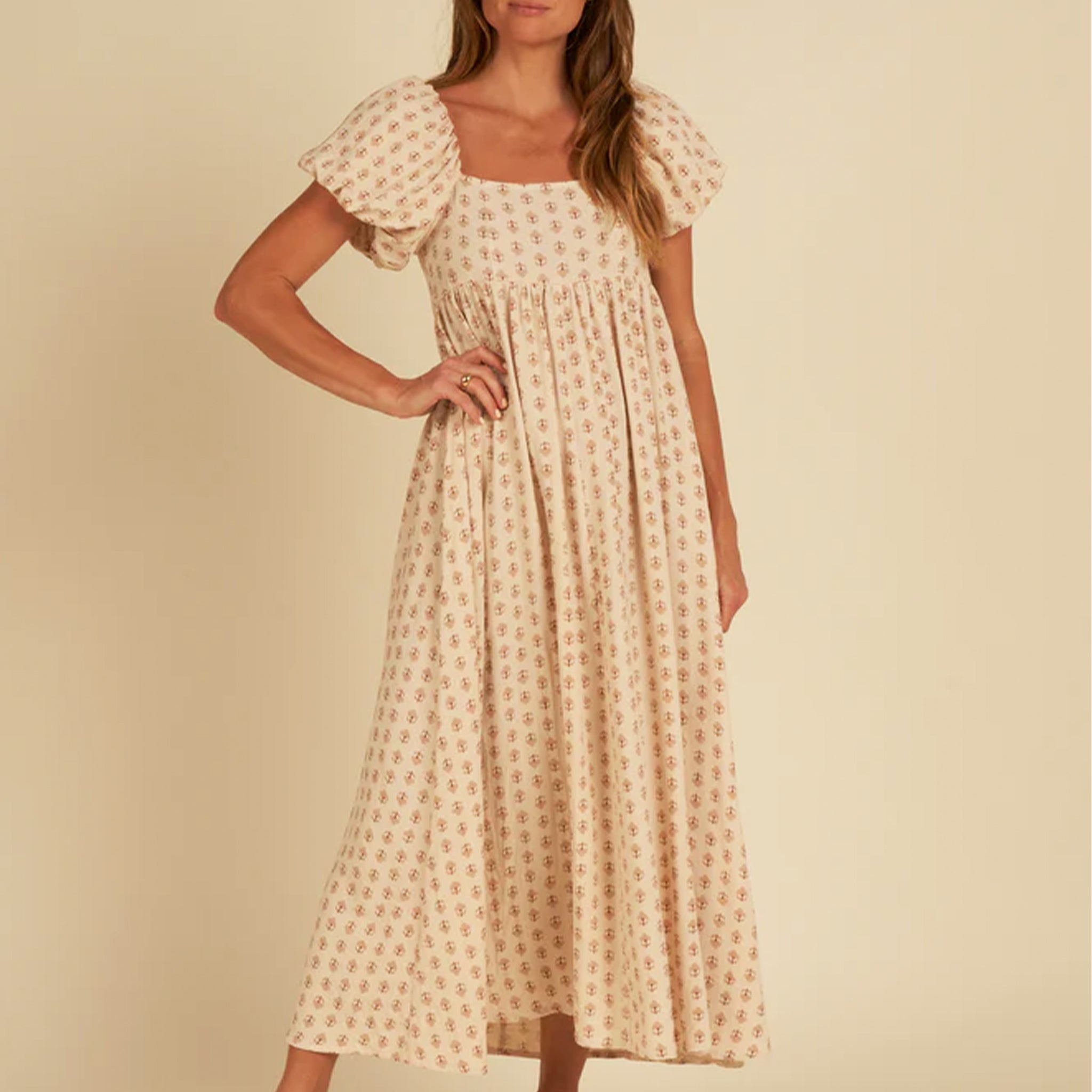 A neutral colored vintage floral print maxi dress with a square neckline and puffy short sleeves. 