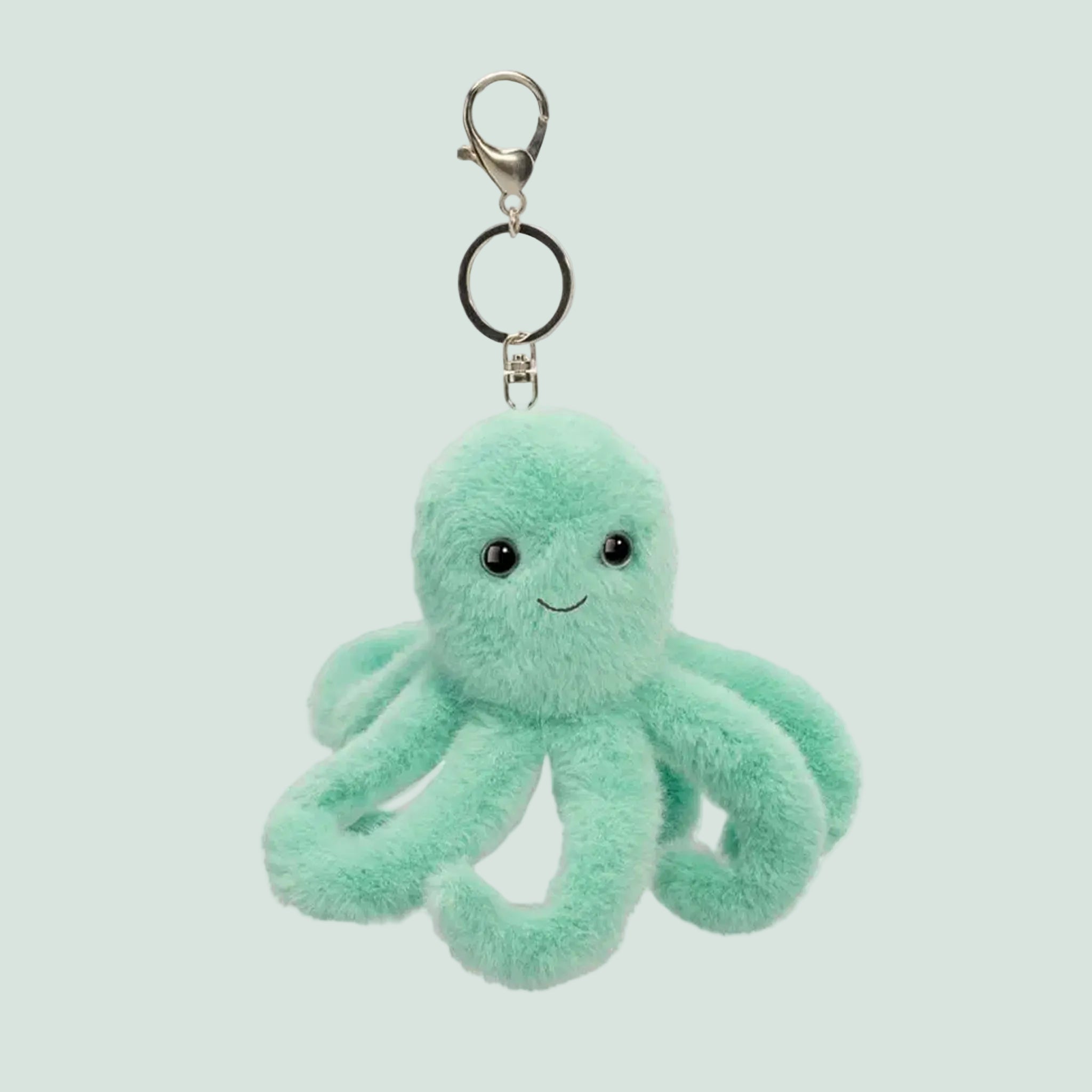 A teal octopus shaped stuffed mini toy on a keychain. 