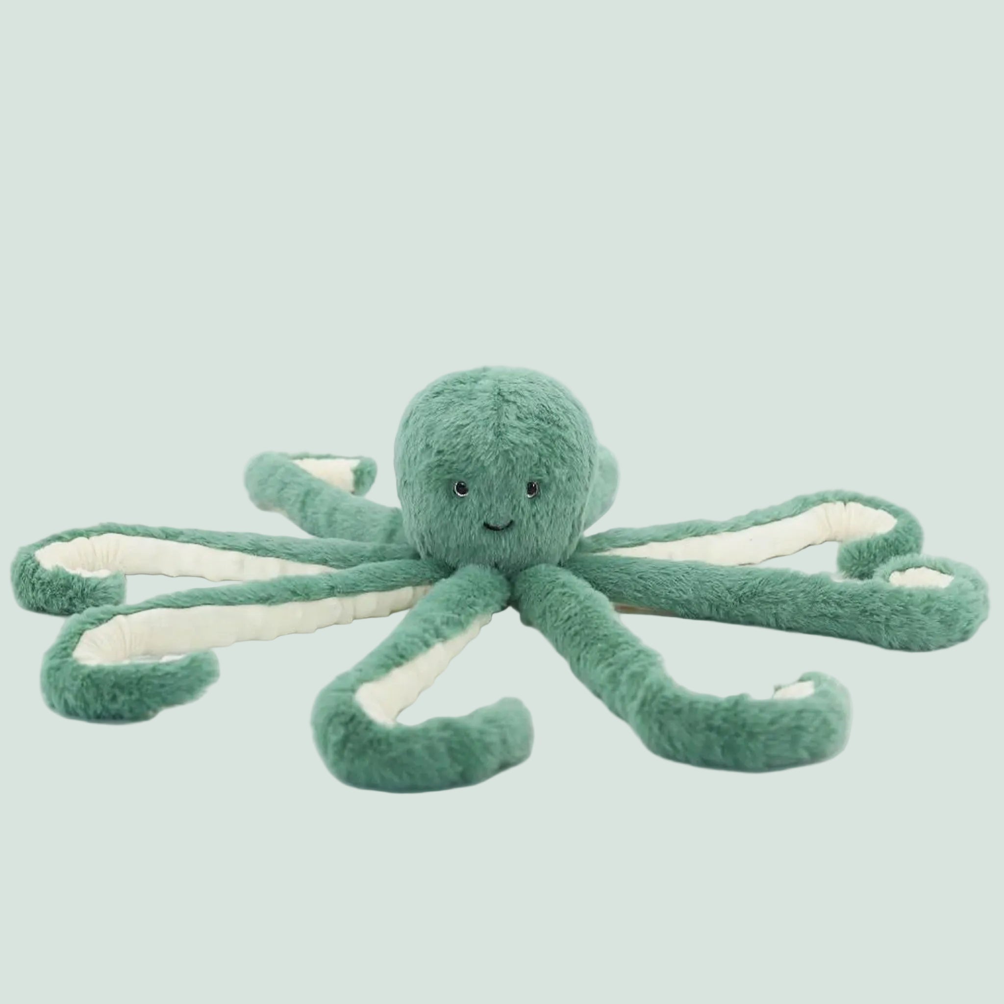 A green octopus shaped stuffed animal toy. 