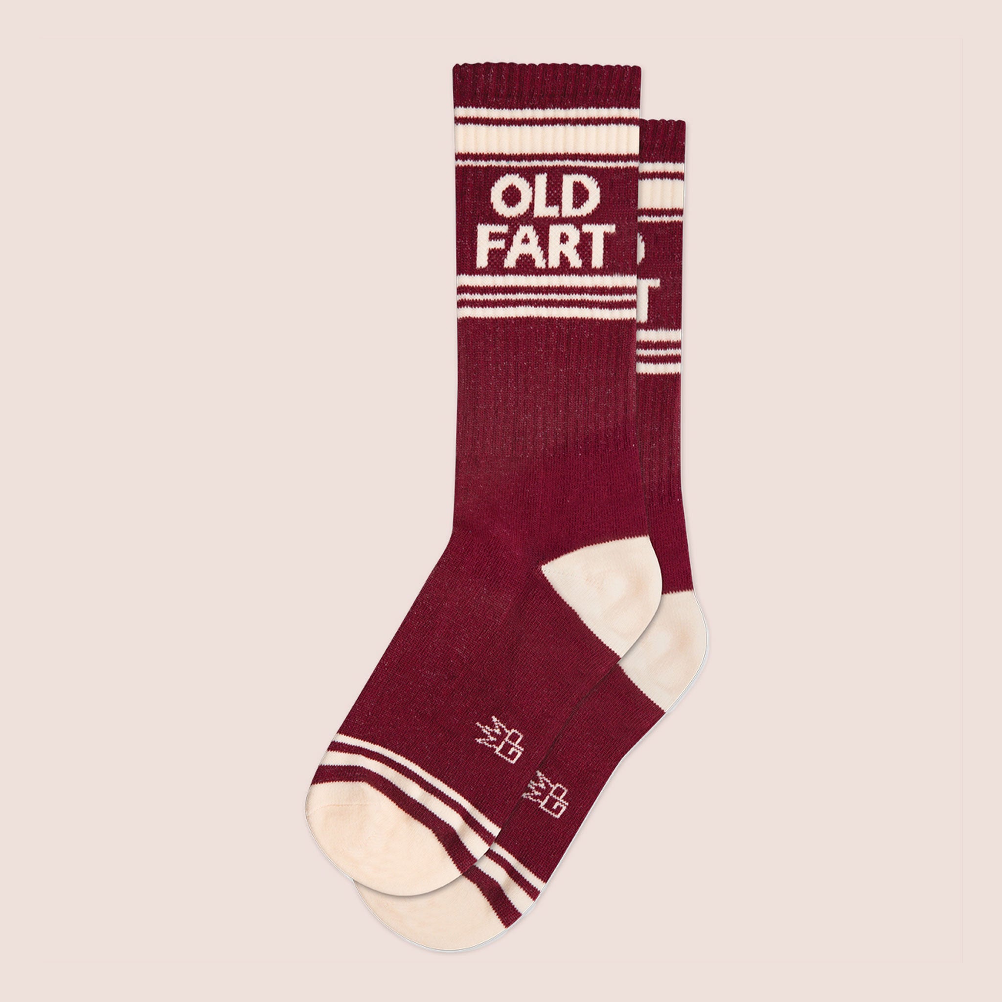 A pair of dark red socks with ivory details and text at the top that reads, &quot;Old Fart&quot;.