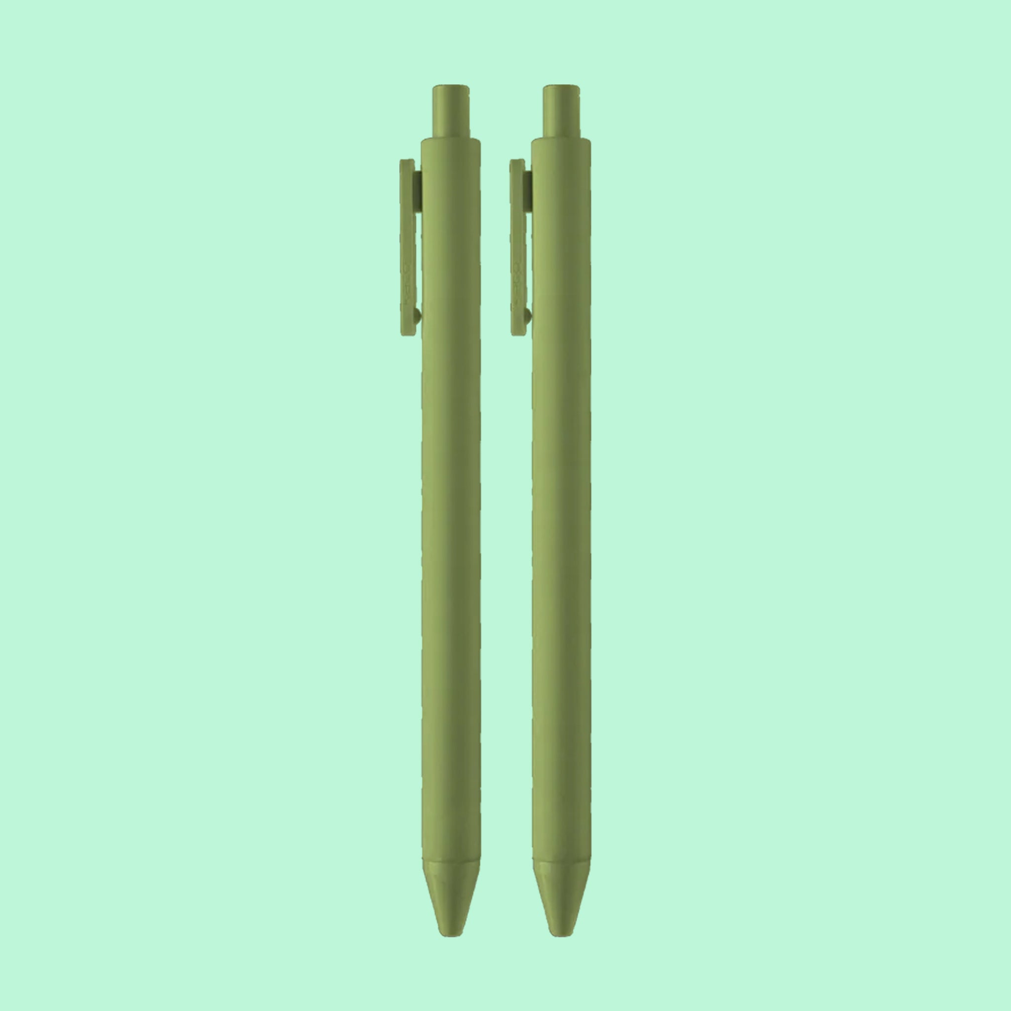 On a green background is an olive green pen set. 