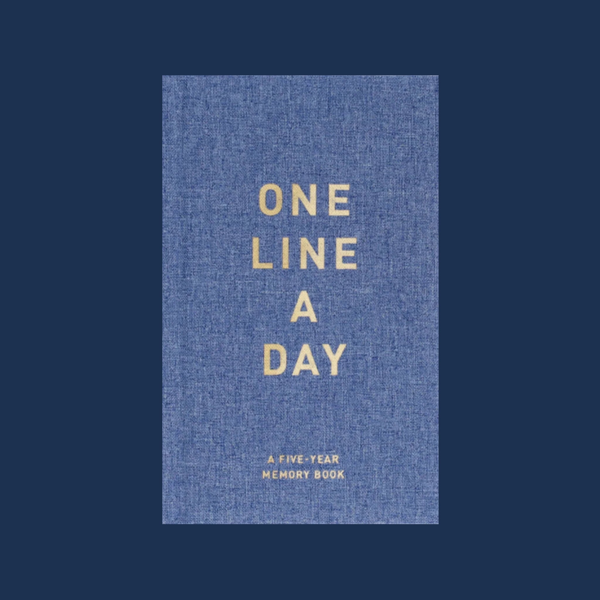 A blue denim journal with neutral text on the front that reads, 'One Line A Day A Five-Year Memory Book'. 