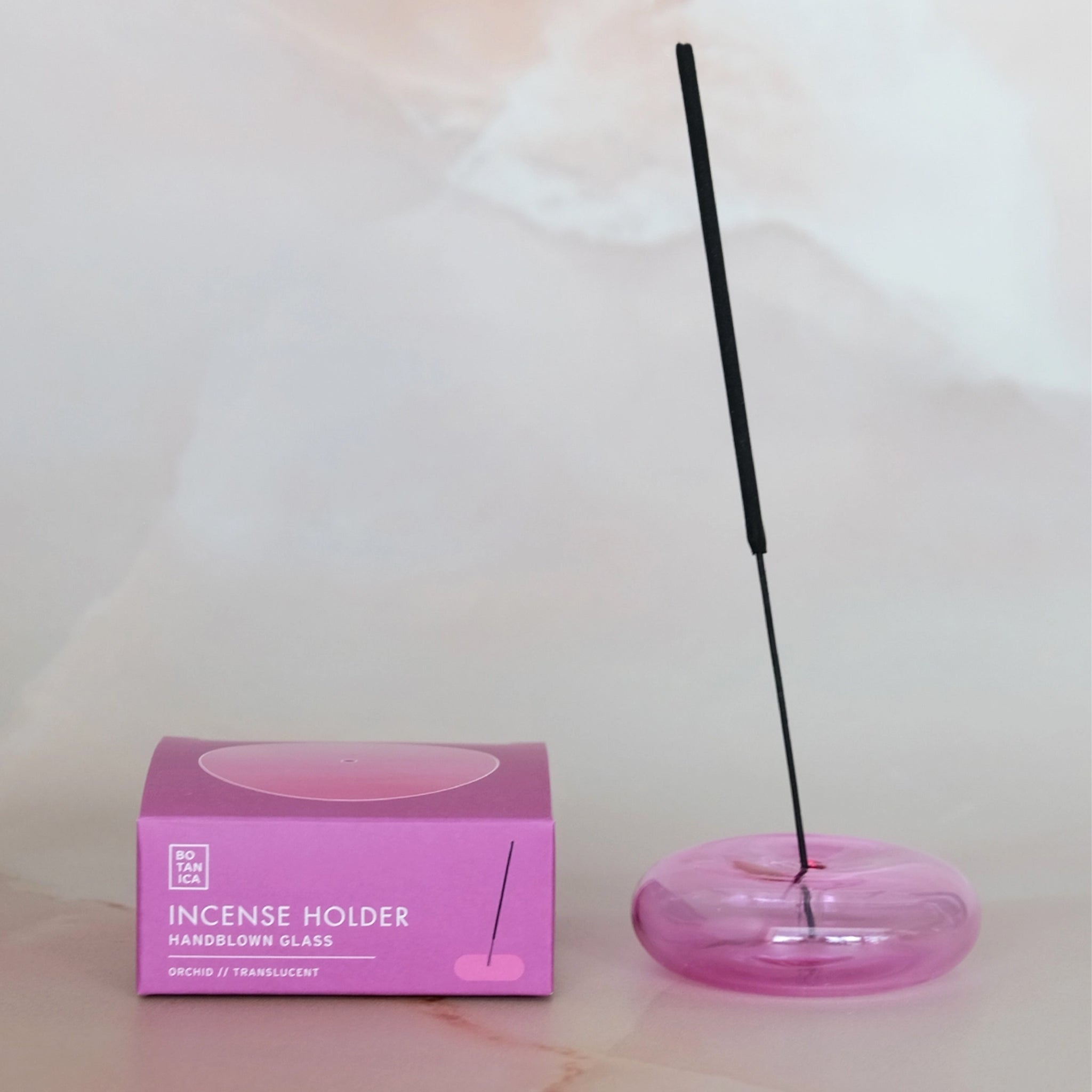 An orchid pink glass bubble incense holder. 