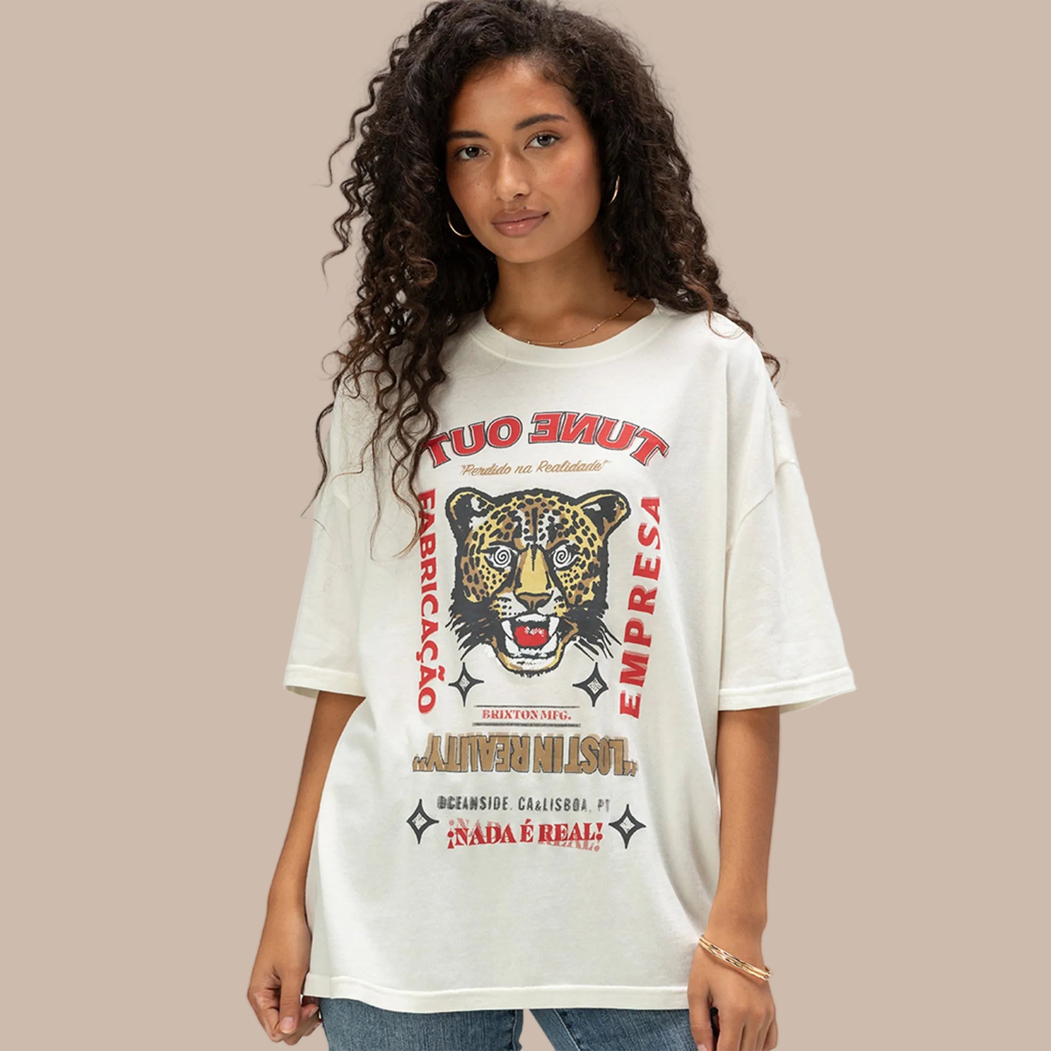 A white oversized BF fit tshirt with a tiger graphic that reads, "Tune Out Fabricacao Empresa Lost In Reality". 
