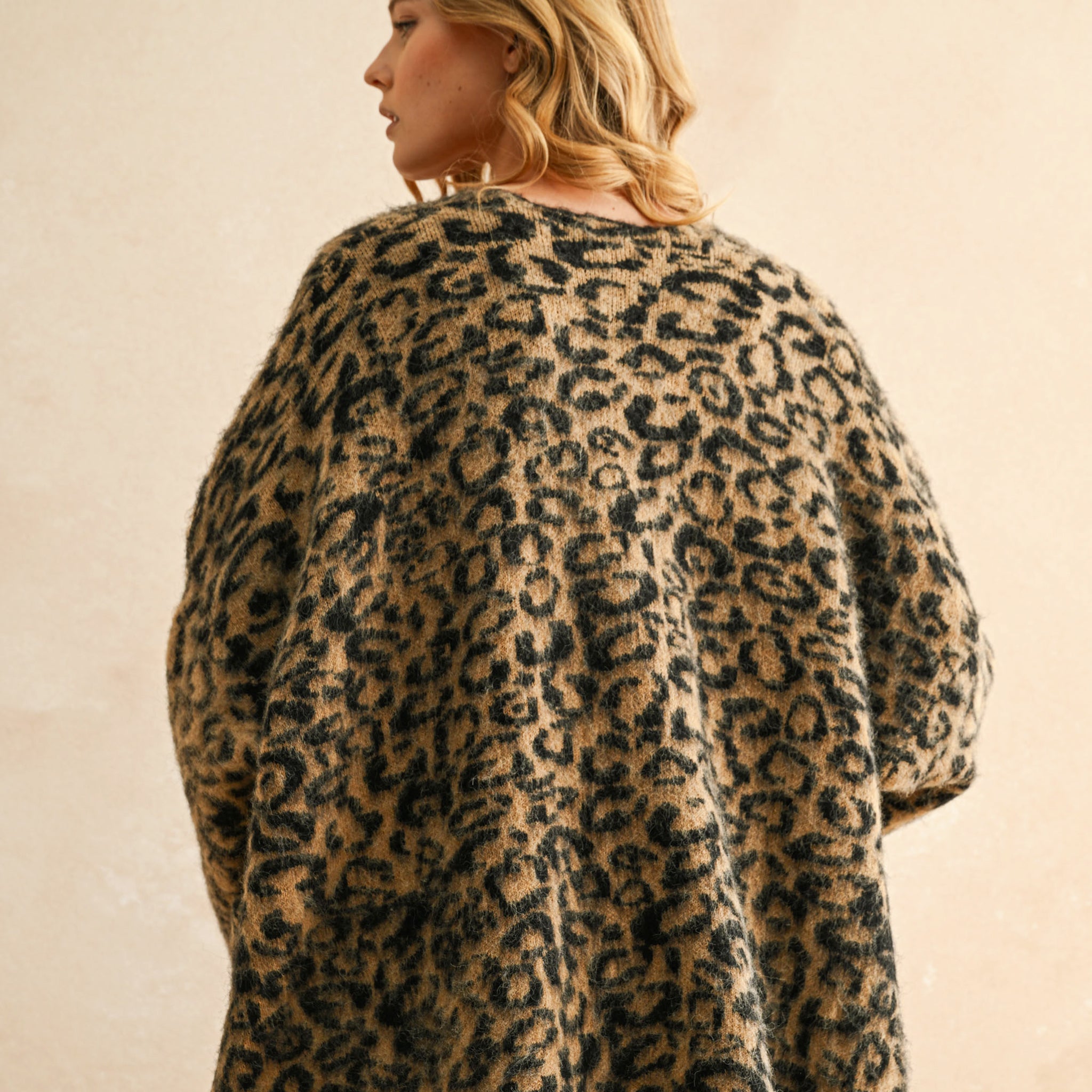 A tan and black leopard print cardigan. 