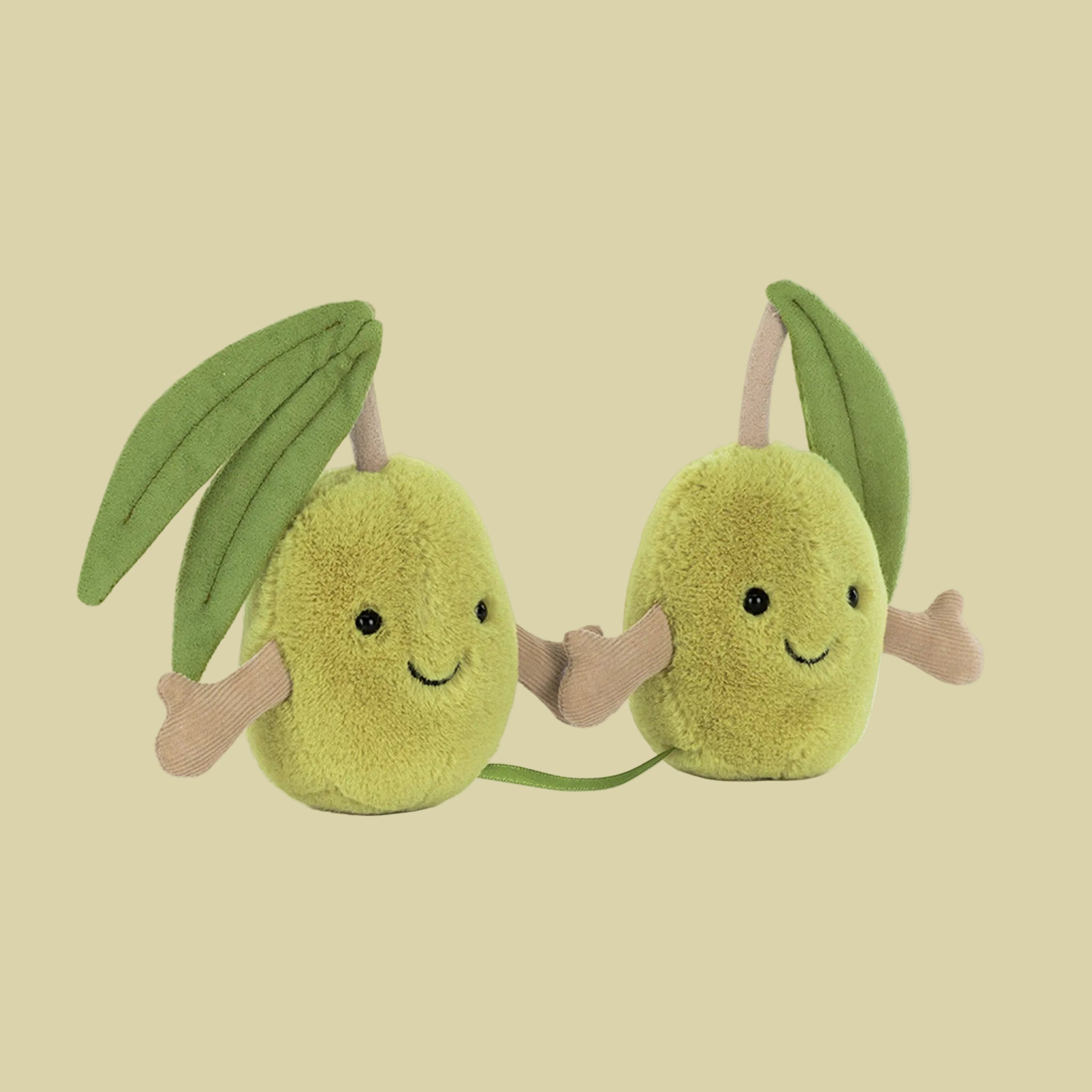 A pair of green olive shaped stuffed toys with smiling faces and hands that connect with velcro. 