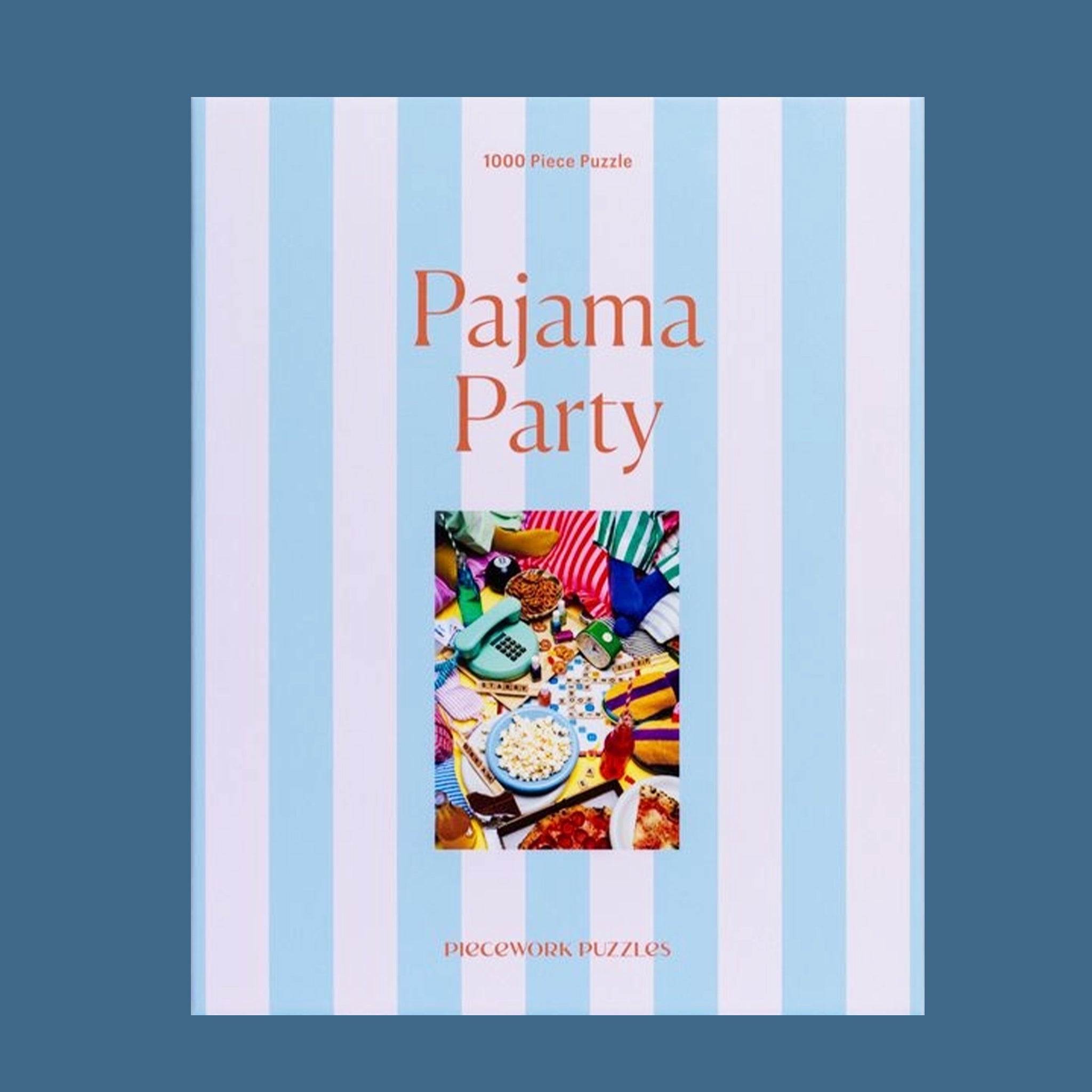A light purple and blue striped puzzle box that reads, "Pajama Party 1000 Piece Puzzle". 
